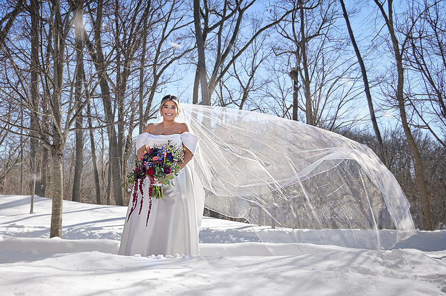 The bride's wedding veil flies in the wind compliments of Sarah, the dressmaker at 2GatherMore in Auburn Hills, Michigan.