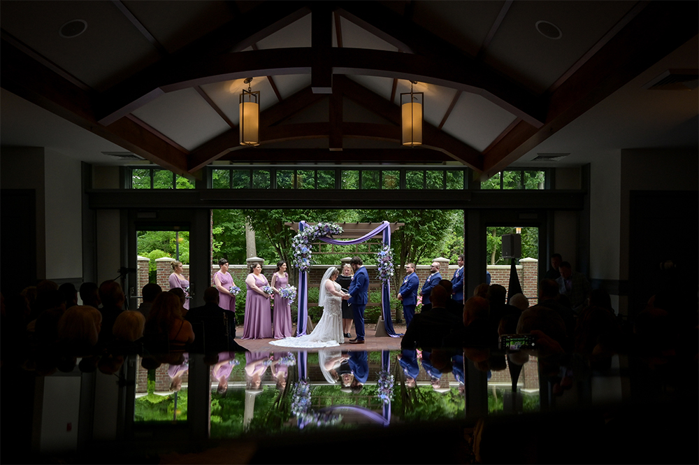 Couple outside for their wedding vows with guests inside at 2GatherMore in Auburn Hills, Michigan.
