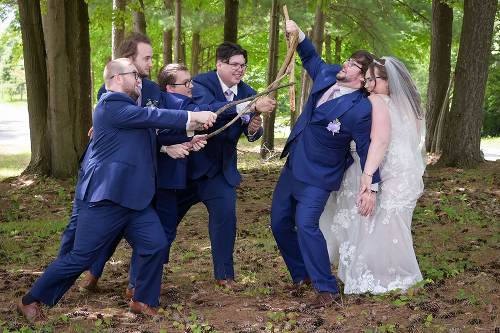 The groom defends the bride in their cos play after their wedding at 2GatherMore in Auburn Hills, Michigan.