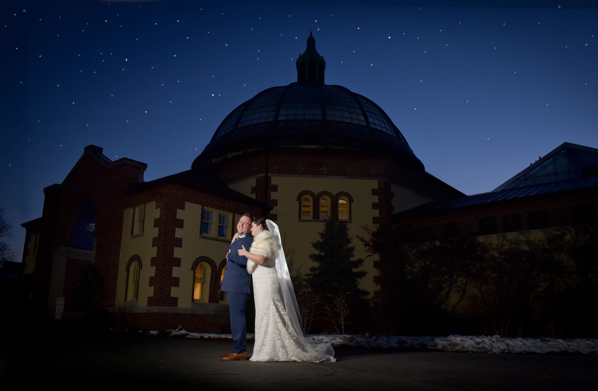 The groom and bride post at sundown at the Detroit Zoo in Royal Oak, Michigan where they had their wedding ceremony.