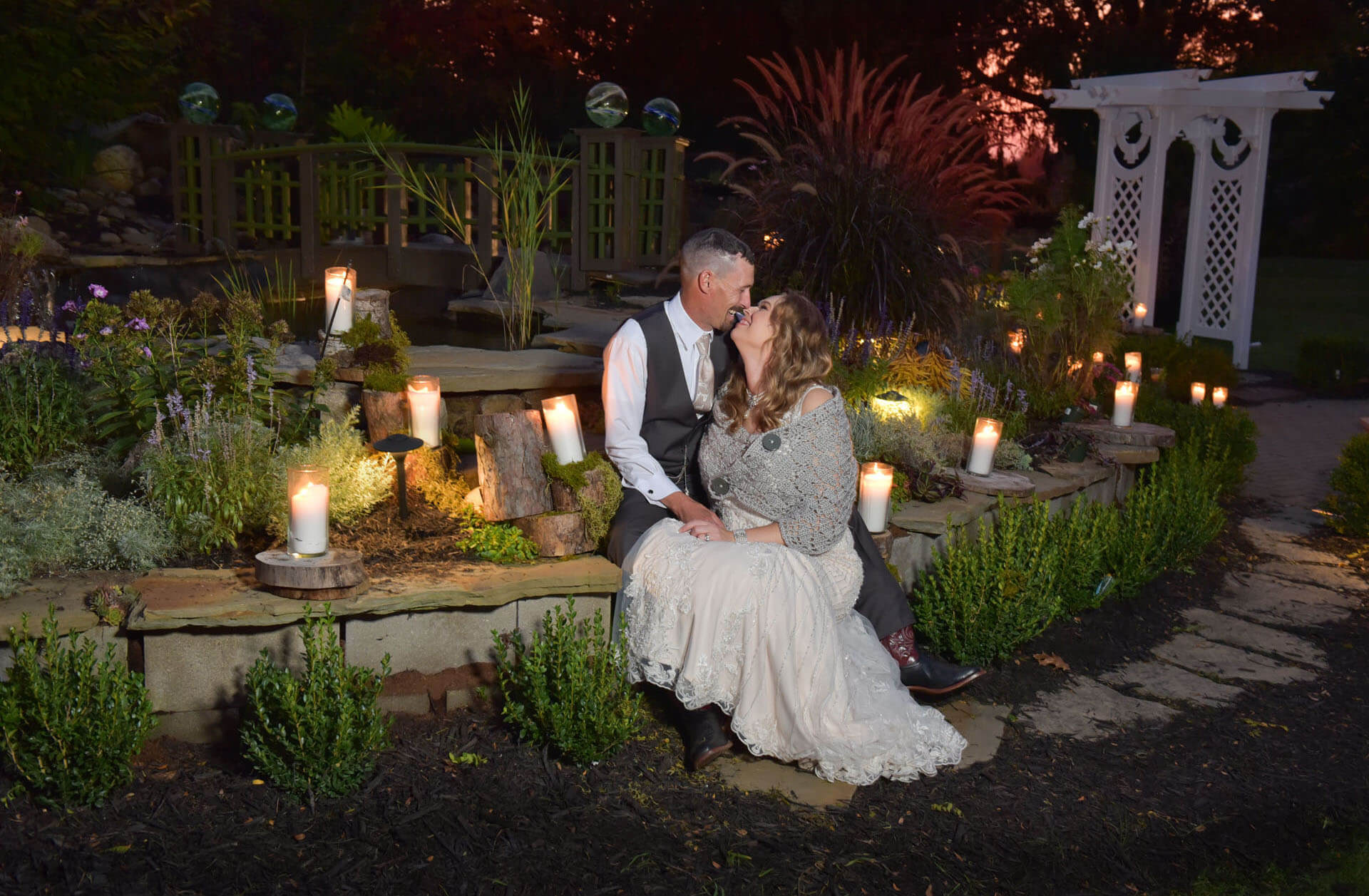 The bride and groom snuggle at the end of their backyard wedding after sunset near Metro Detroit, Michigan.