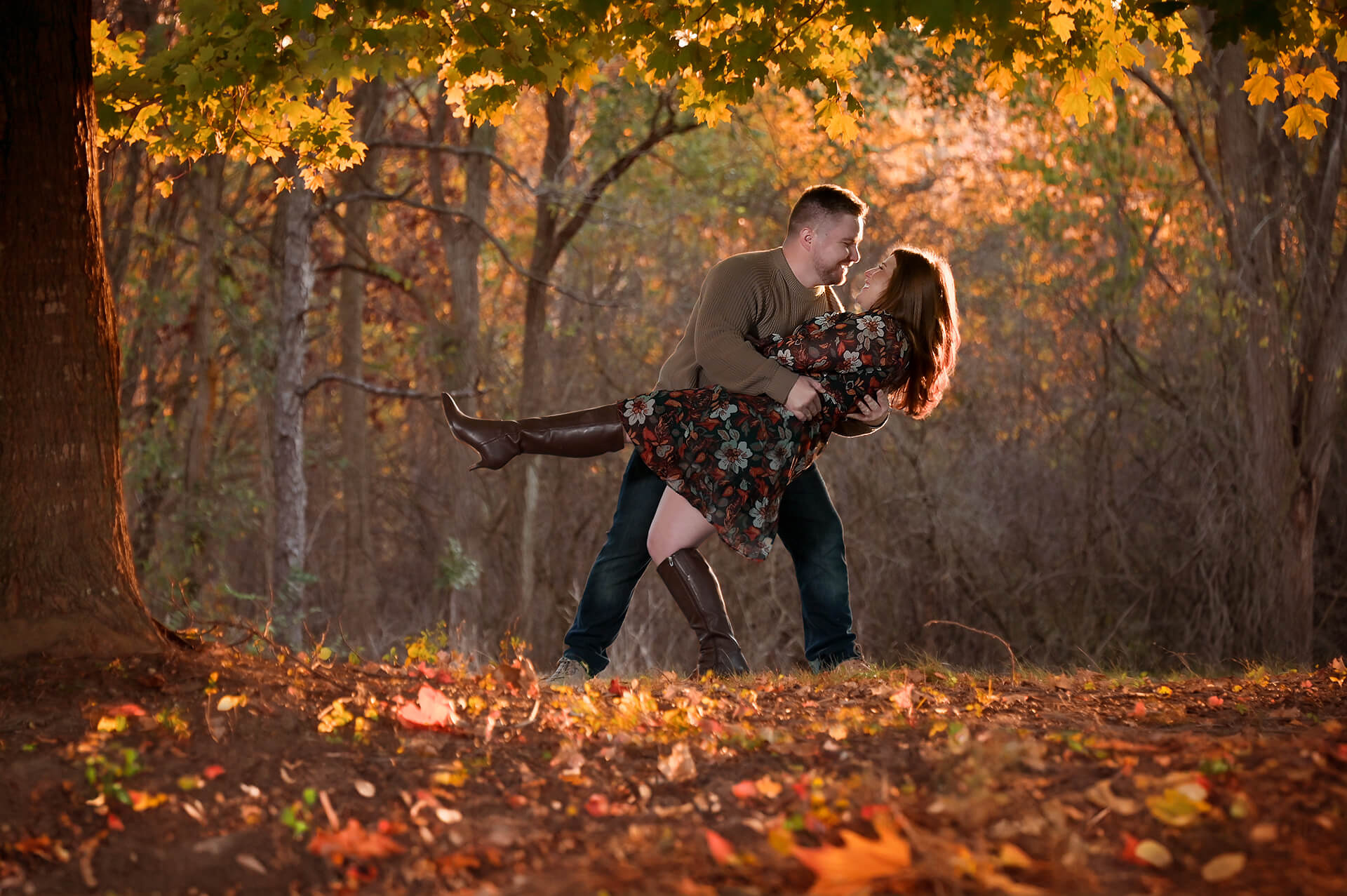 Engagement photographer photographs clients during golden hour in fall leaves in beautiful light like this couple in a Metro Detroit, Michigan park.