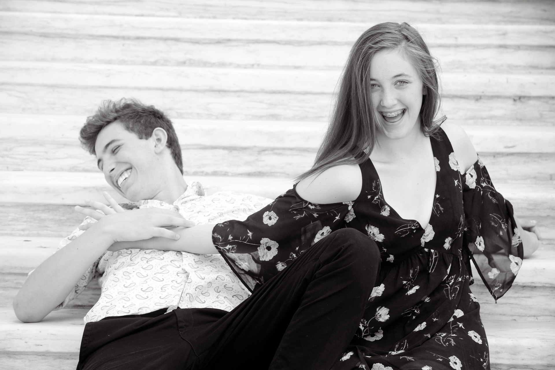 Best Detroit family photographer's fun and candid family photos of two siblings trying to out do each other during a lifestyle photography session in downtown Detroit, Michigan.