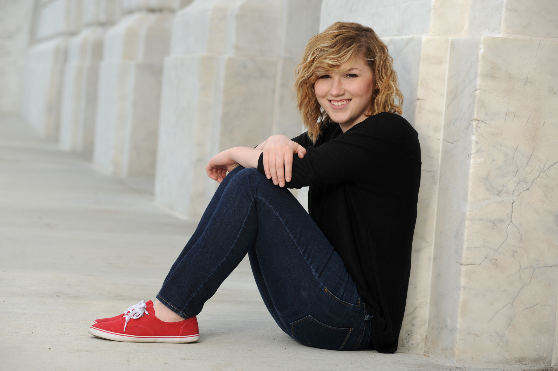 Best Detroit senior photographer's high school senior picture of a senior making the most of classic architecture in downtown Detroit, Michigan.