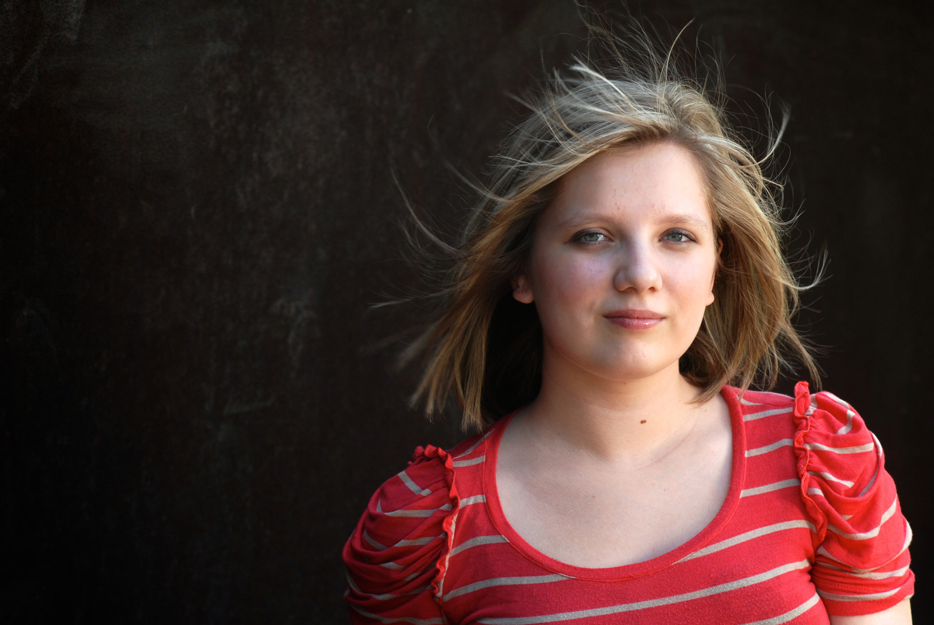 Best Detroit senior photographer's high school senior picture of a wind blown senior in great light from downtown Detroit, Michigan.