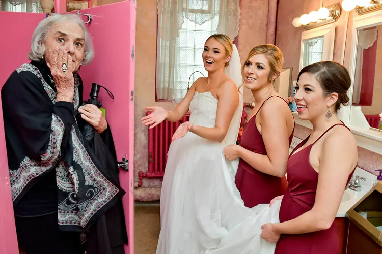 Creating works of art during any given Metro Detroit, Michigan wedding is part of my job as a favorite Detroit based wedding photographer like this Grandmother interrupting a moment in the bathroom between the bride and her wedding party in downtown Detroit.