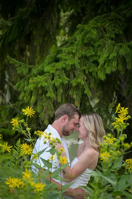 An engagement couple snuggle in Birmingham, Michigan during this sweet floral engagement session.