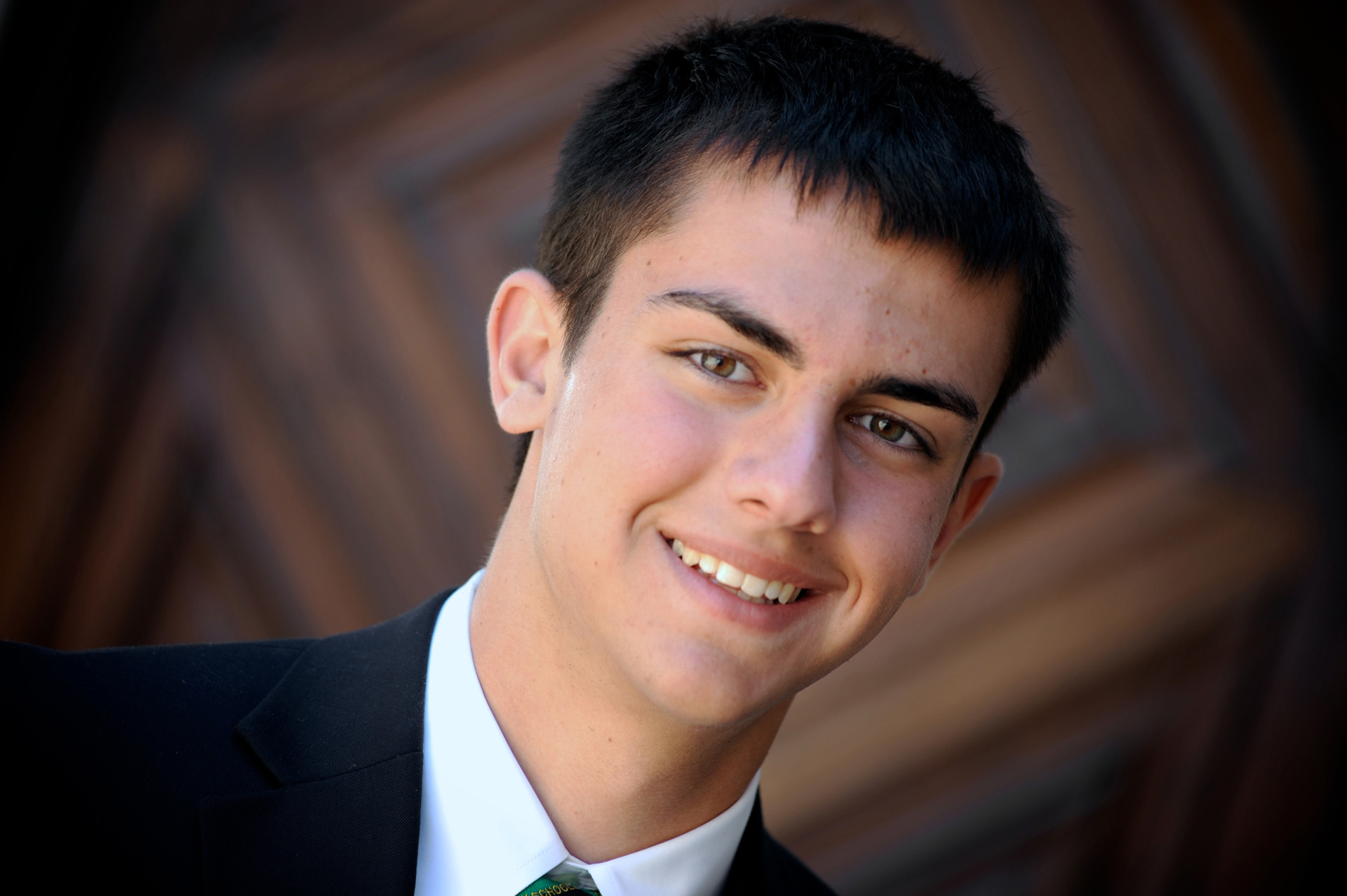 Cranbrook School in Bloomfield, Michigan senior pictures photo of a Cranbrook high school senior in front of one of their many amazingly crafted wood doors at the Cranbrook School in Bloomfield, Michigan.