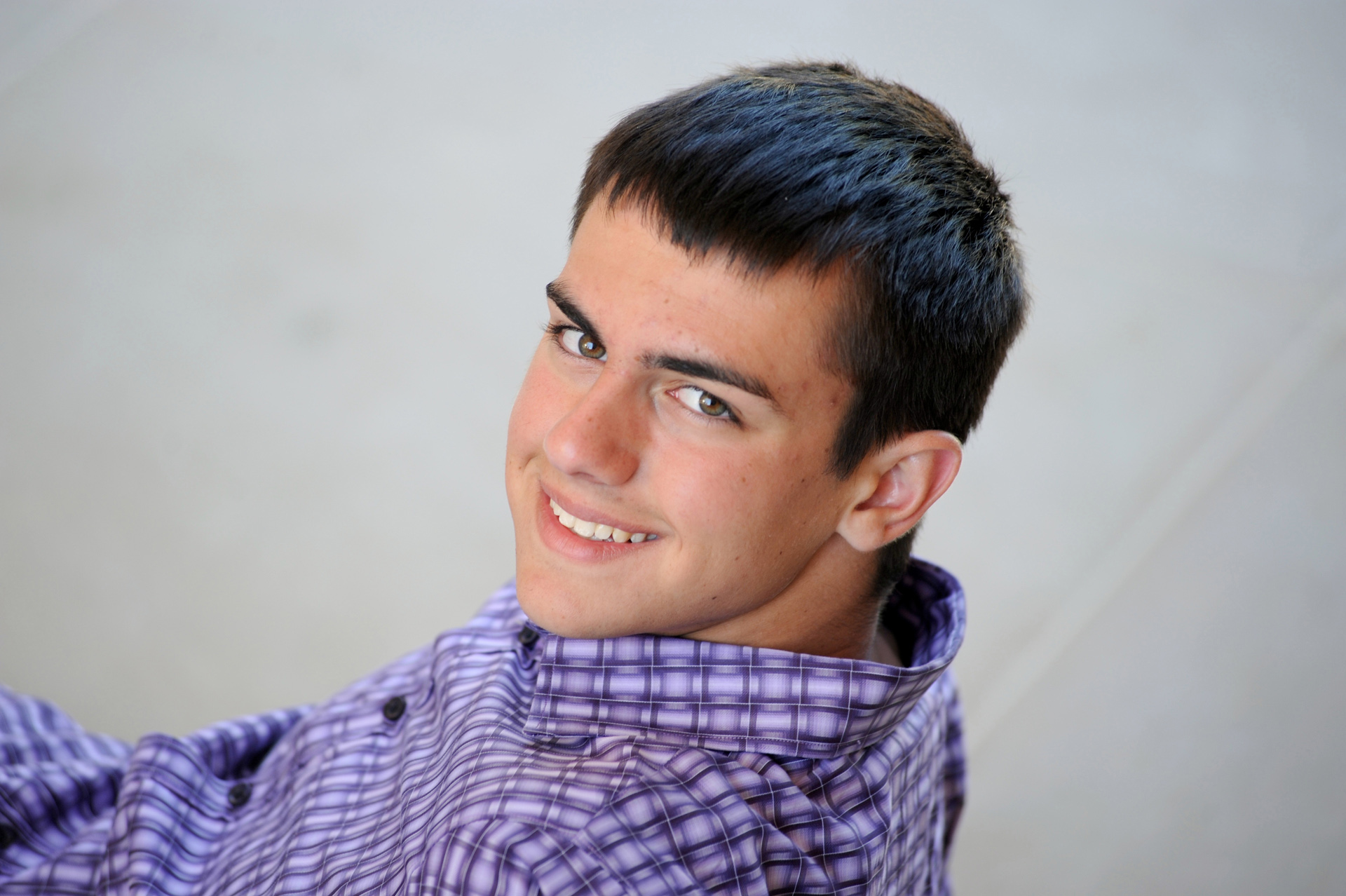 Cranbrook School in Bloomfield, Michigan senior photographer shows a Cranbrook high school senior poses on the steps at Cranbrook for his Senior Photo shoot.