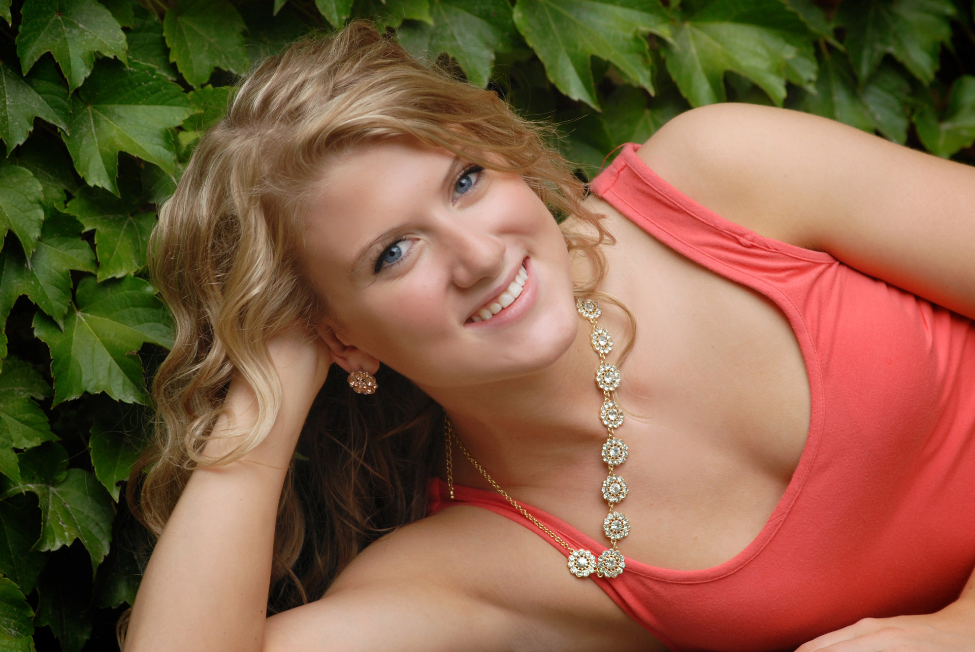Cranbrook School in Bloomfield, Michigan senior pictures photo taken of the high school senior poses with a tiny piece of ivy at the Cranbrook School in Bloomfield, Michigan.