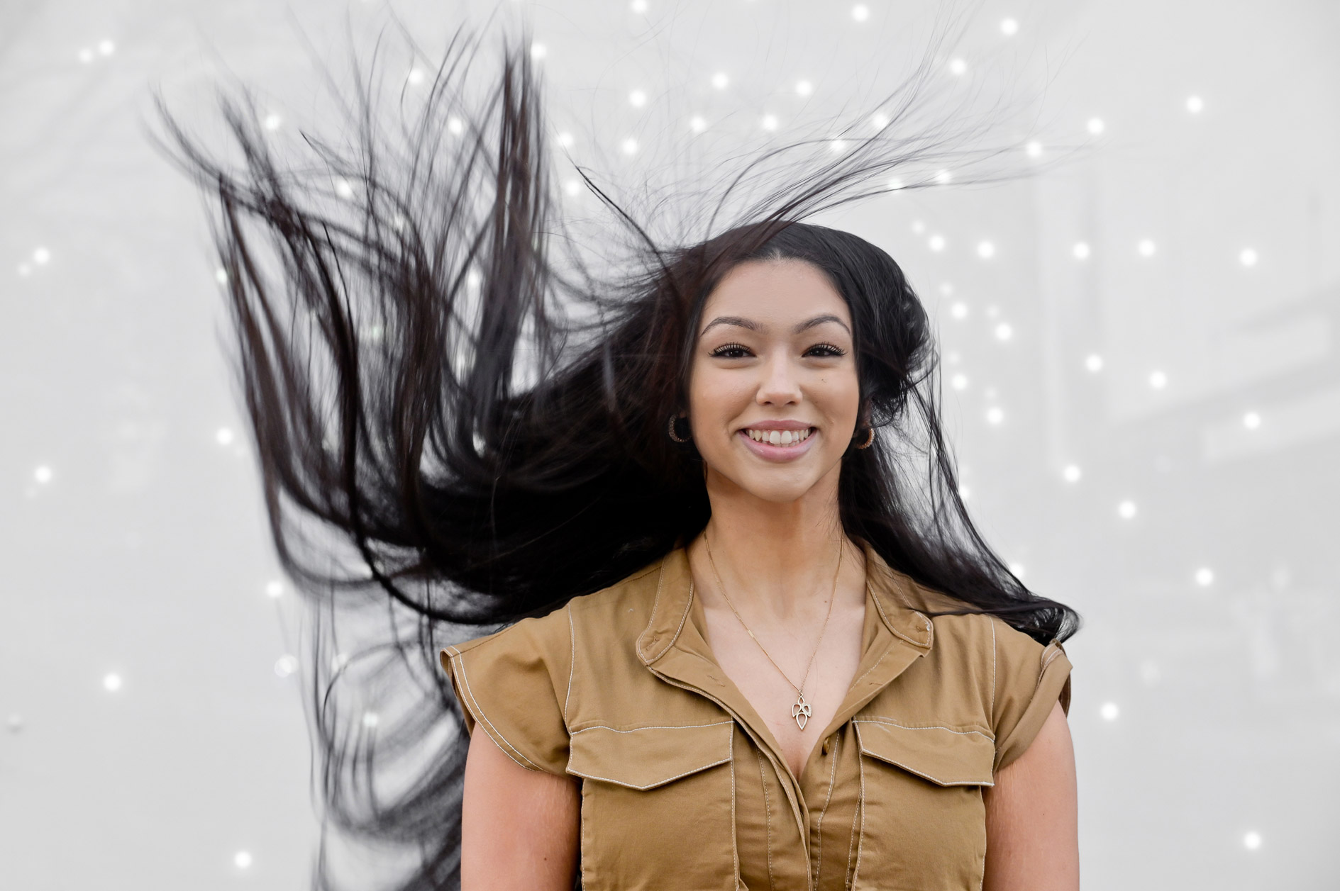 A high school senior girl's hair goes wild at a found art installation in Detroit, Michigan.