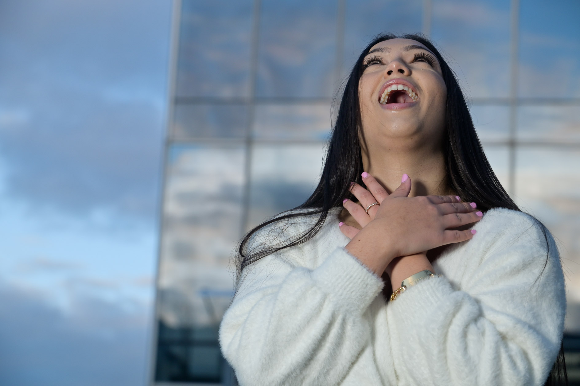 A high school senior girl joking around during her senior session in Detroit, Michigan.
