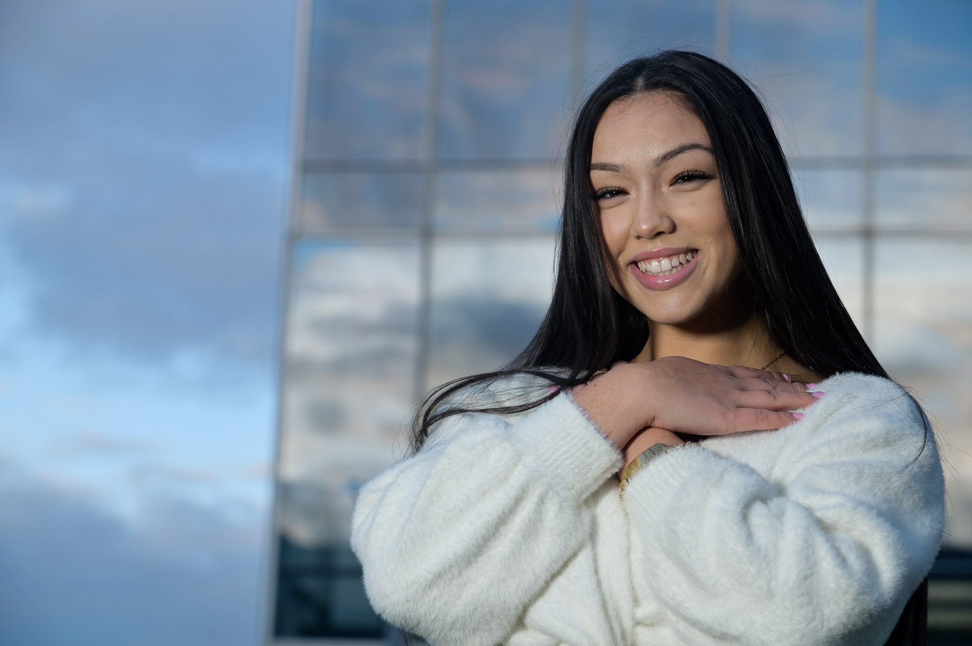 A high school senior girl poses for her senior pictures in Detroit, Michigan.