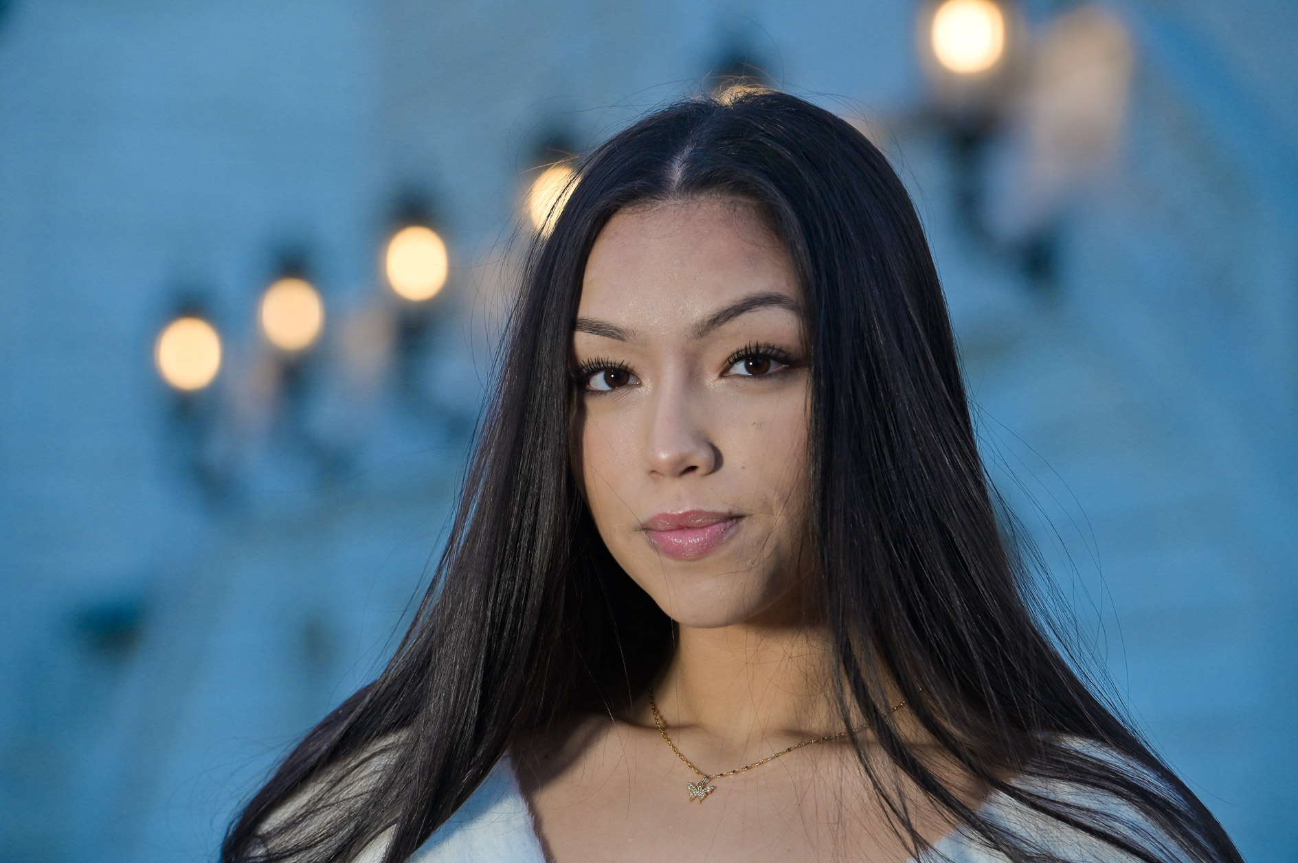 A high school senior girl poses at the Detroit Institute of Arts in Detroit, Michigan.
