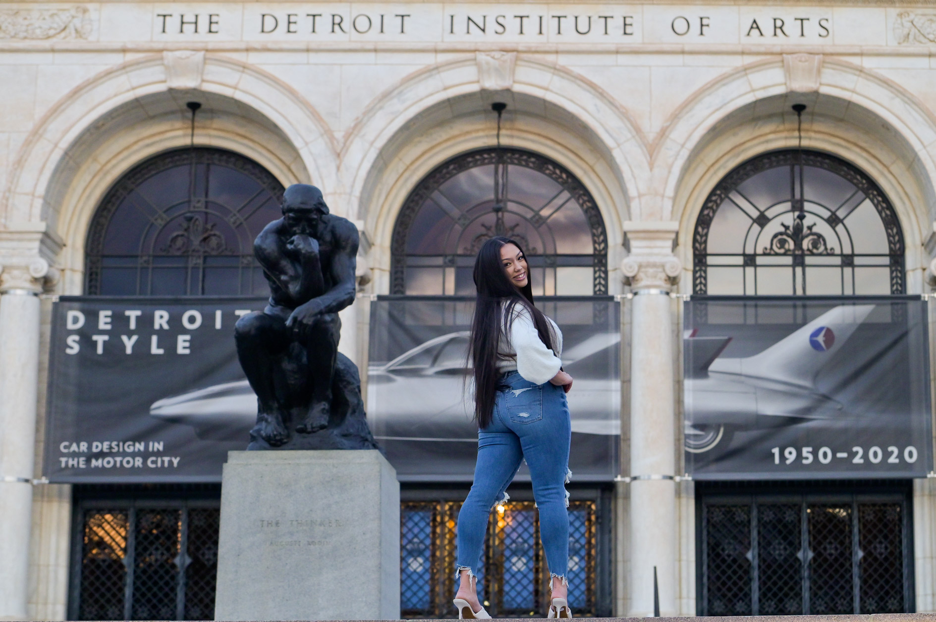 A high school senior girl being photographed at the Detroit Institute of Arts in Detroit, Michigan.