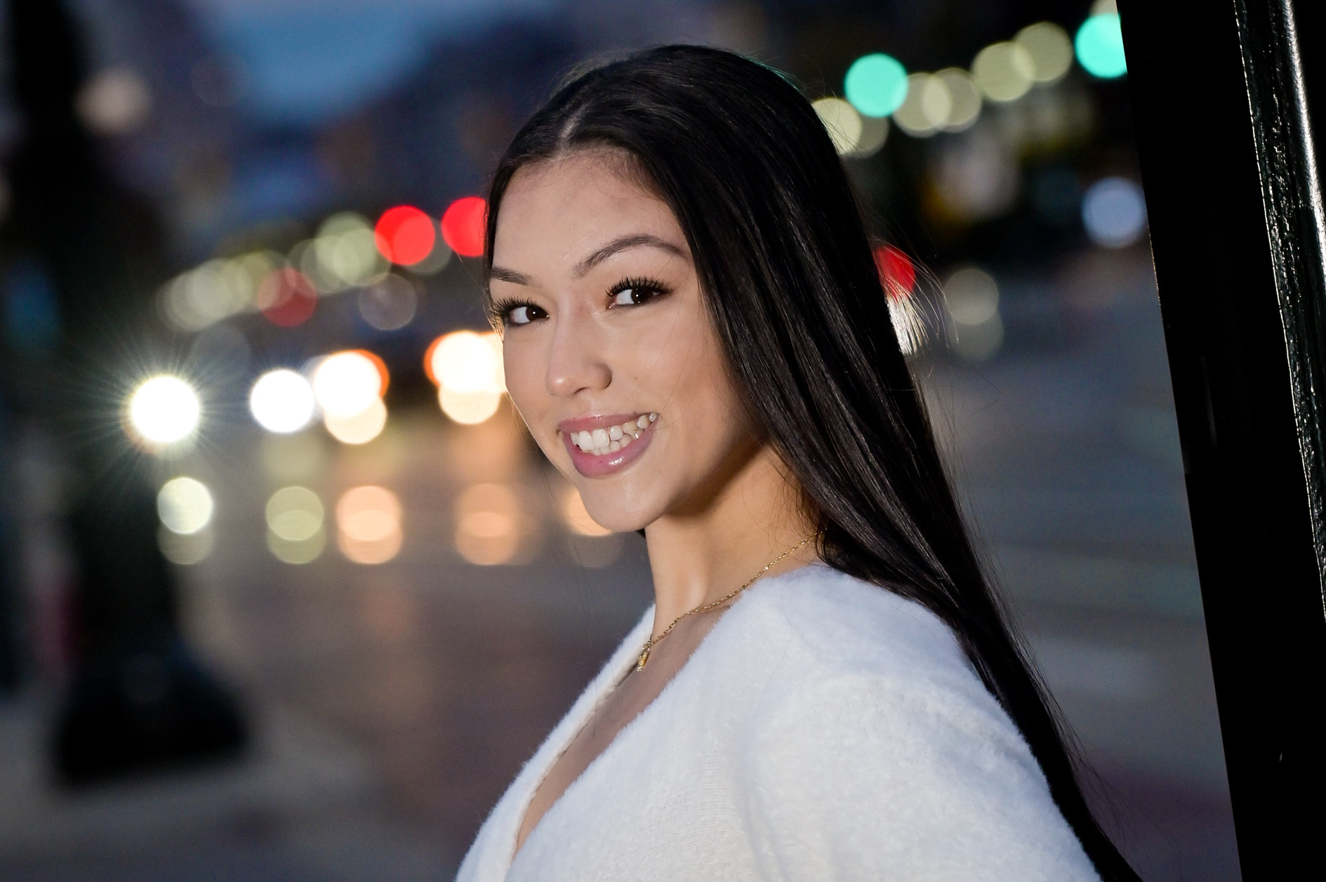 A high school senior girl in the night traffic in Detroit, Michigan.