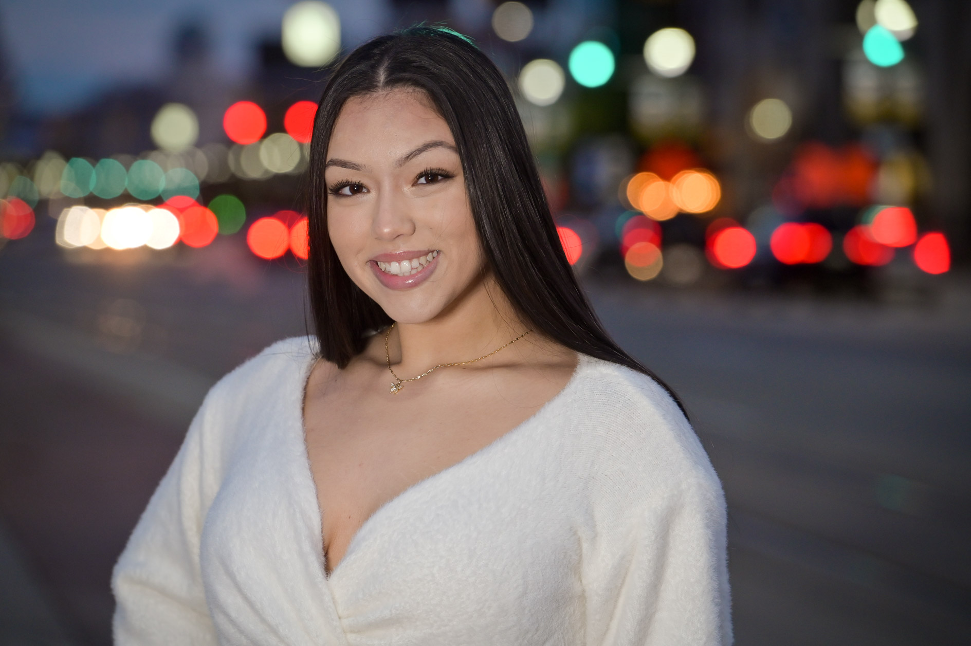 A high school senior girl in the night traffic in Detroit, Michigan.