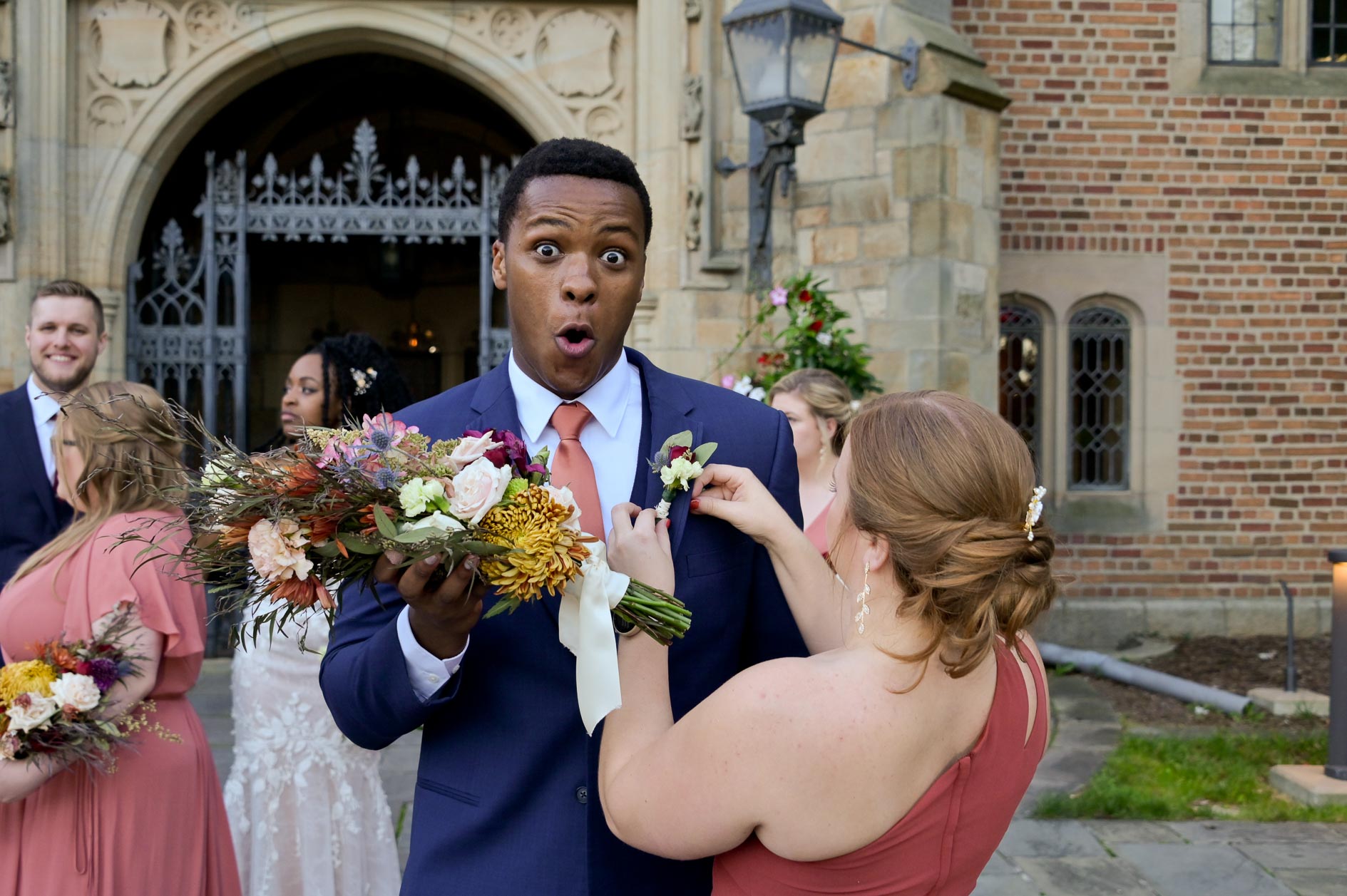A groomsman gets stabbed getting his boutonniere pinned on at Meadowbrook hall in Rochester , Michigan.