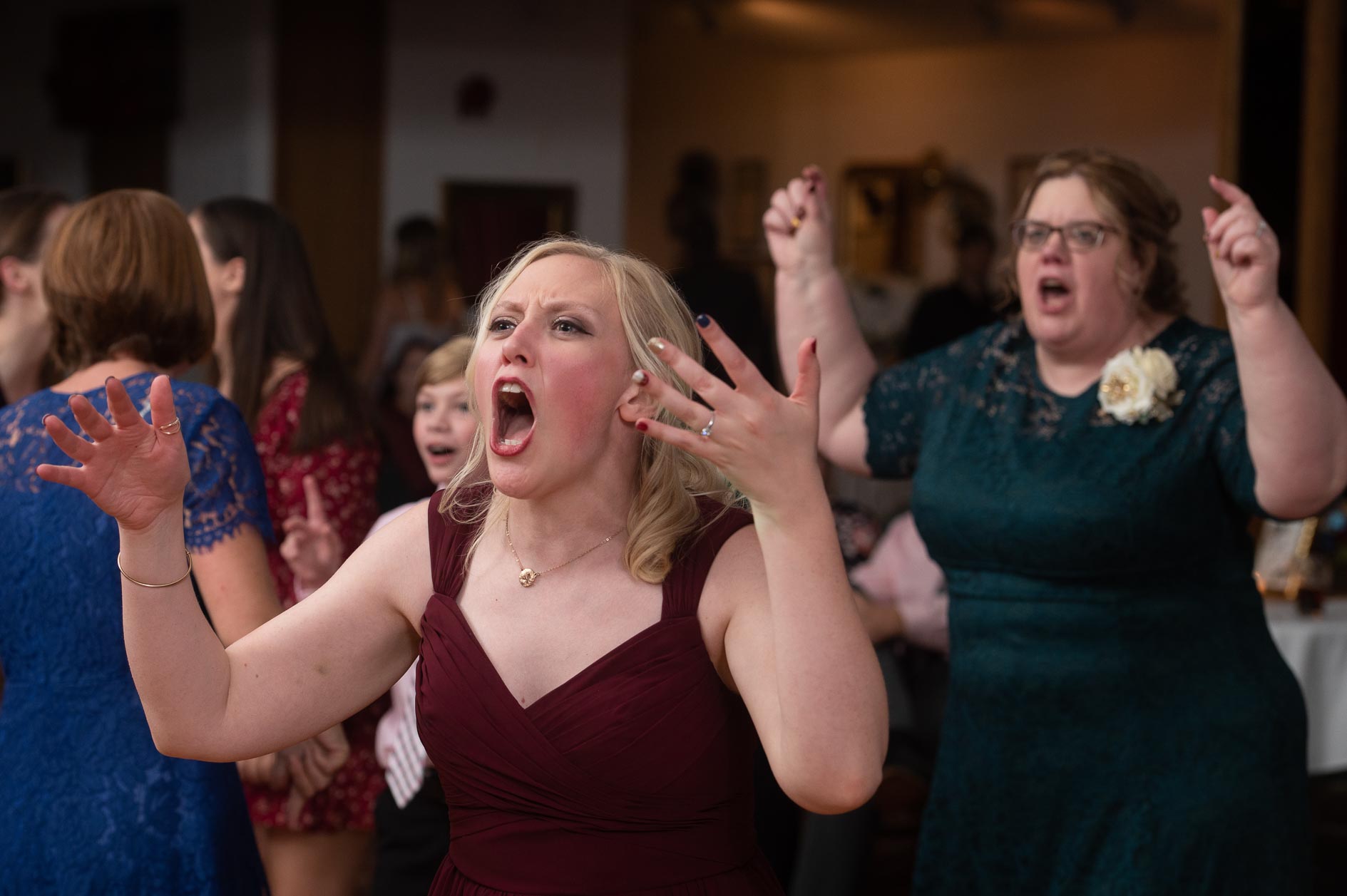 A bridesmaid screams along with a live band at a wedding in Frankenmuth, Michigan.