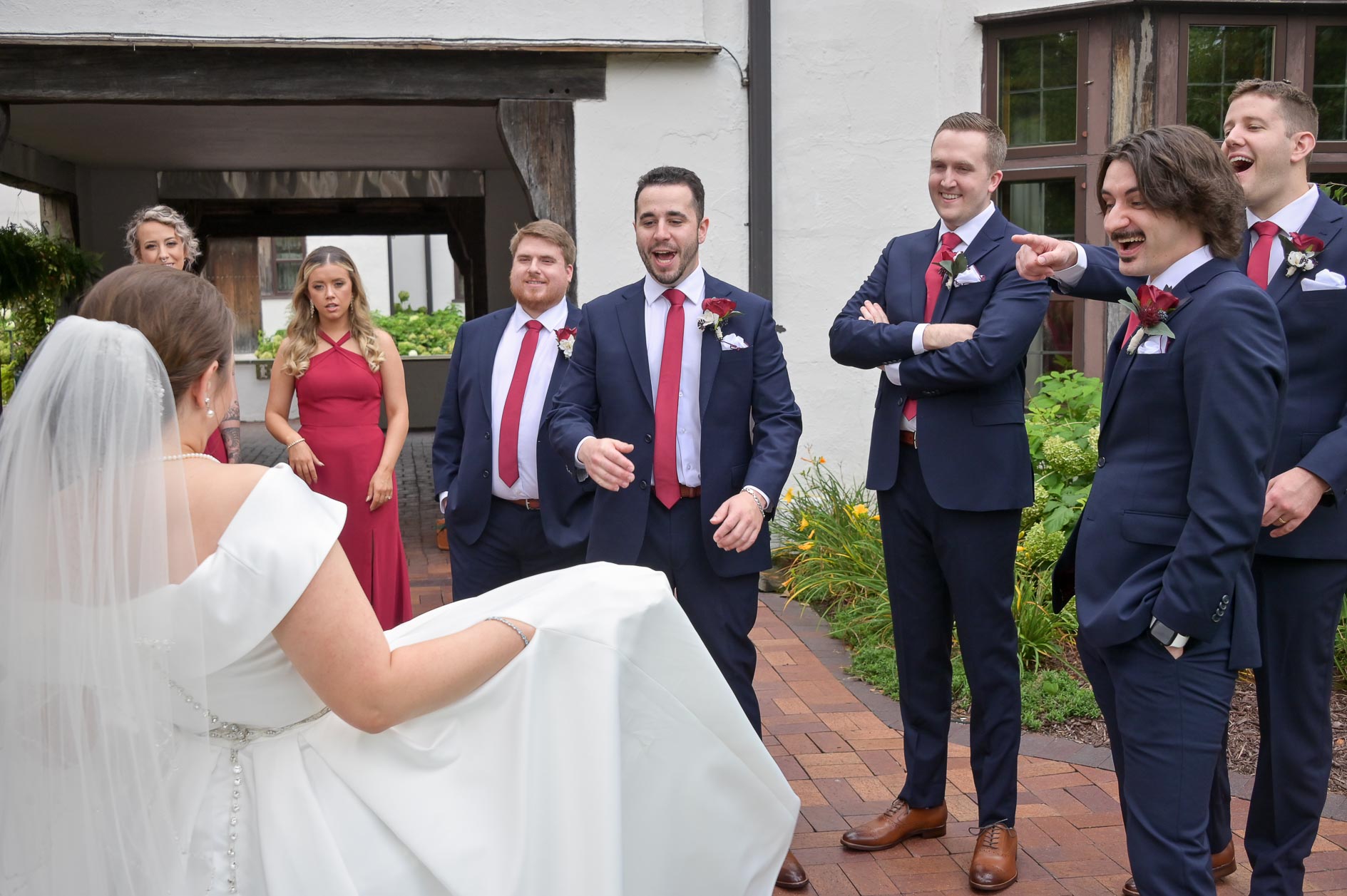 The bride isn't flashing the wedding party, she's just showing off the pockets in her wedding dress at the Buhl Estates at Addison Oaks in Leonard, Michigan.