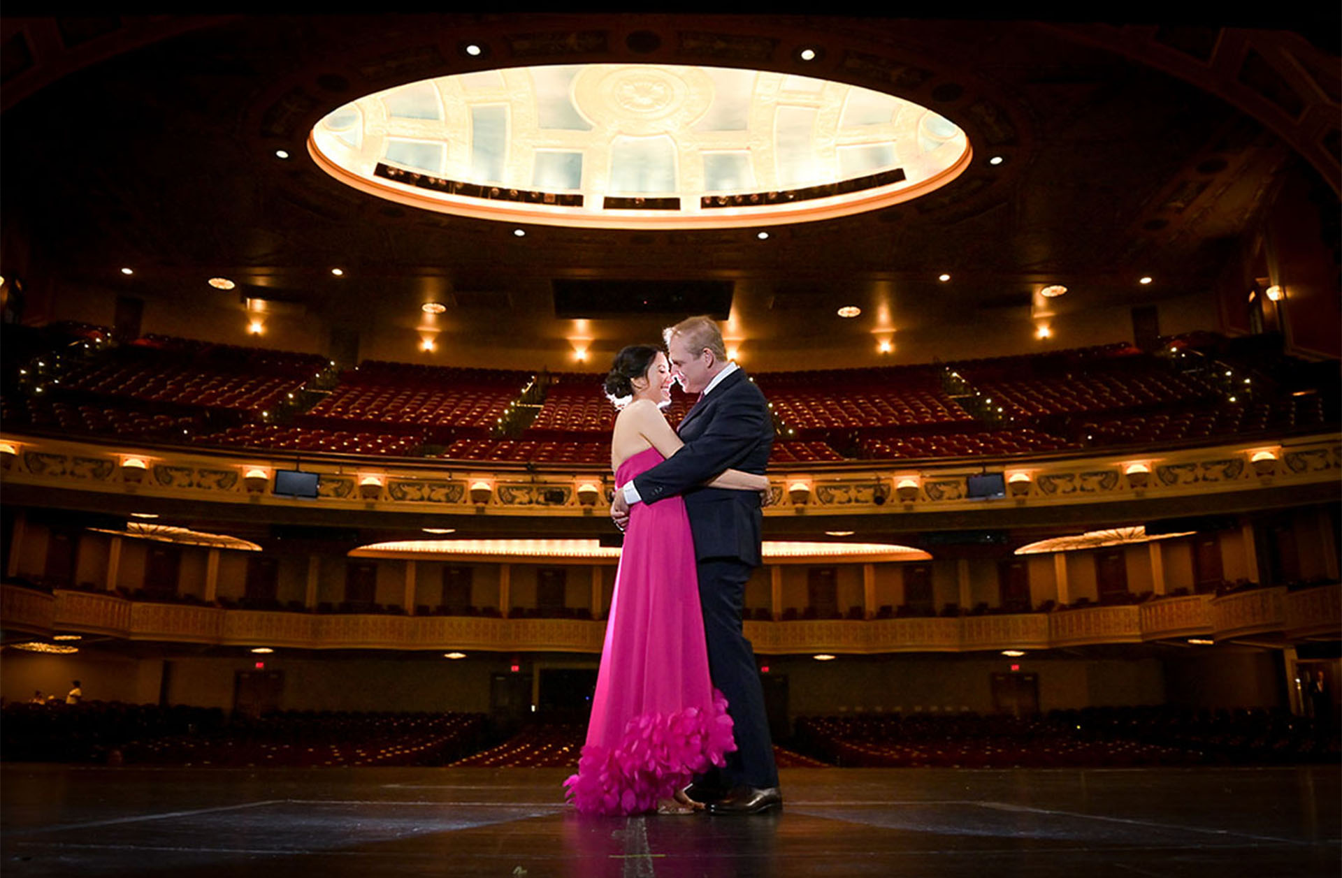 This lovely, mature couple pose on the stage of the Detroit Opera House before their wedding for a classic, timeless wedding portrait.
