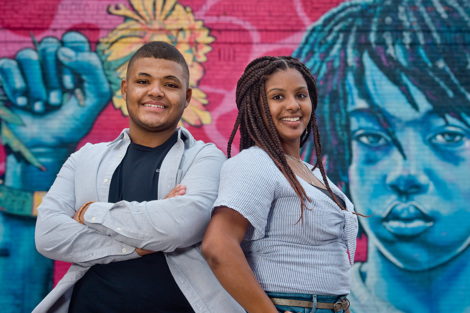 High school senior twins pose with an iconic wall mural at Eastern Market in Detroit, Michigan.