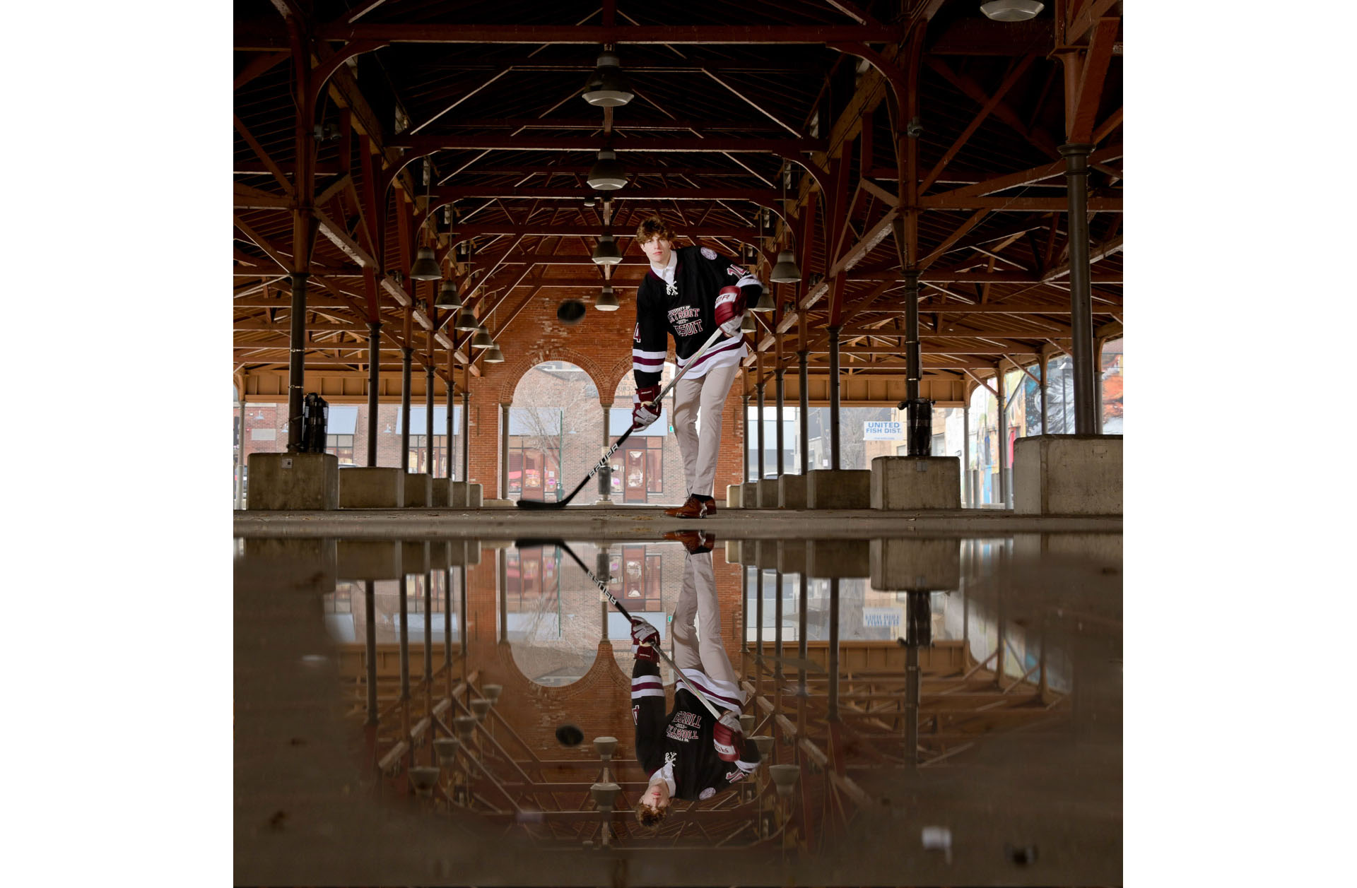 University of Detroit Jesuit High School senior practices hockey in a puddle at Detroit's Eastern Market.