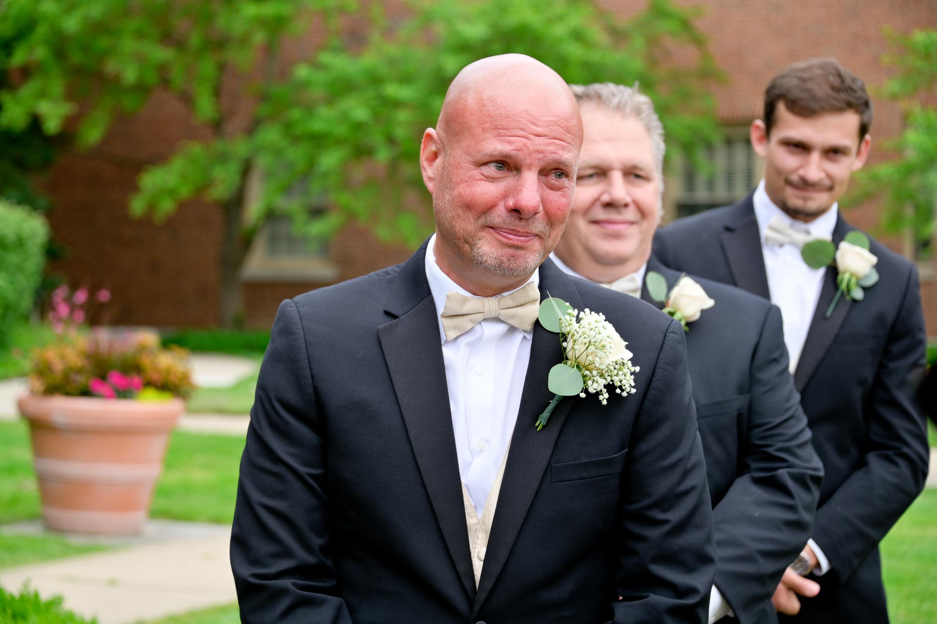 The groom bursts into tears at the sight of his millennial bride walking down the aisle at the Dearborn Inn in Dearborn, Michigan.