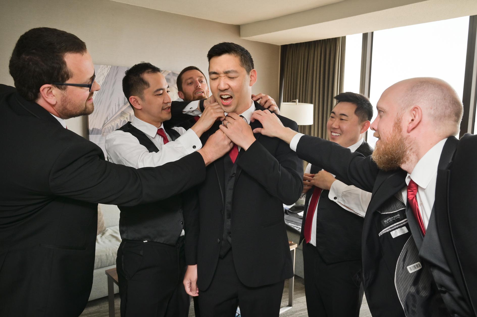 The groom gets a bit more help than he needs from his friends before his Waterview Loft wedding in Detroit, Michigan.