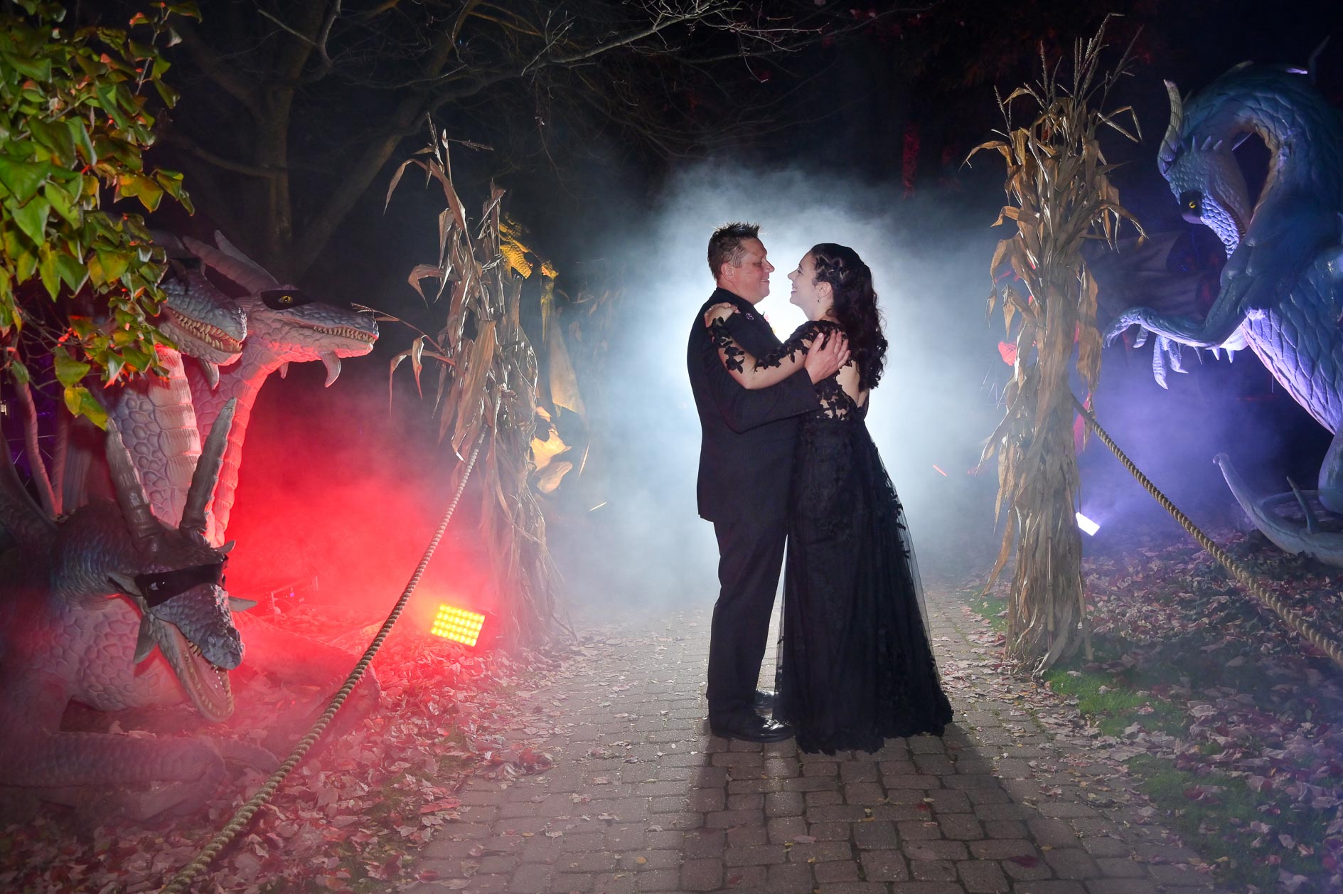 Love this dramatic wedding portrait taken of an older couple at the Canterbury Village in Lake Orion, Michigan for their Halloween themed wedding with dragons and spooky sets.