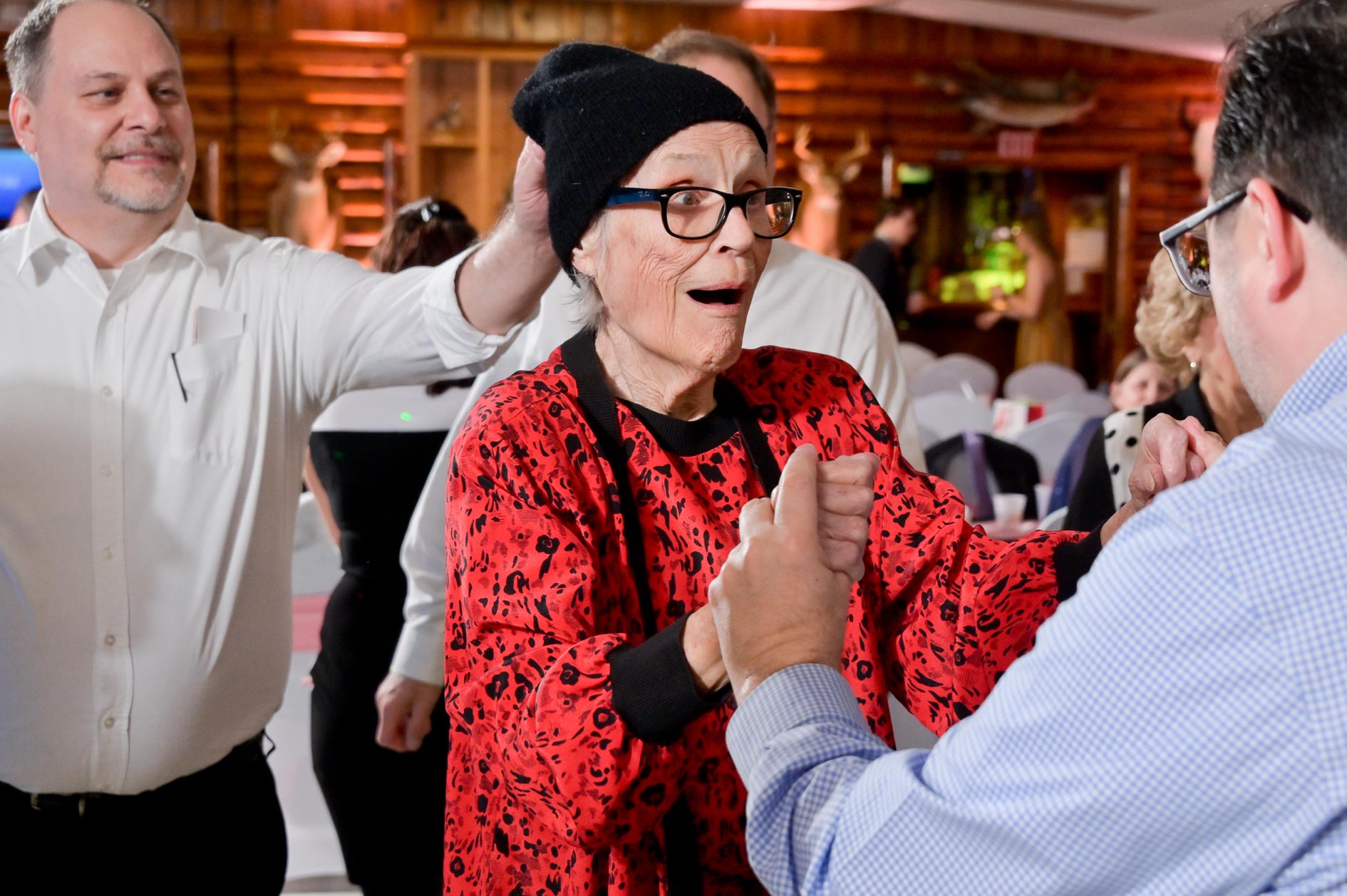 A wedding guest tries to remove another guest's hat during a winter wedding in Clarkston, Michigan.