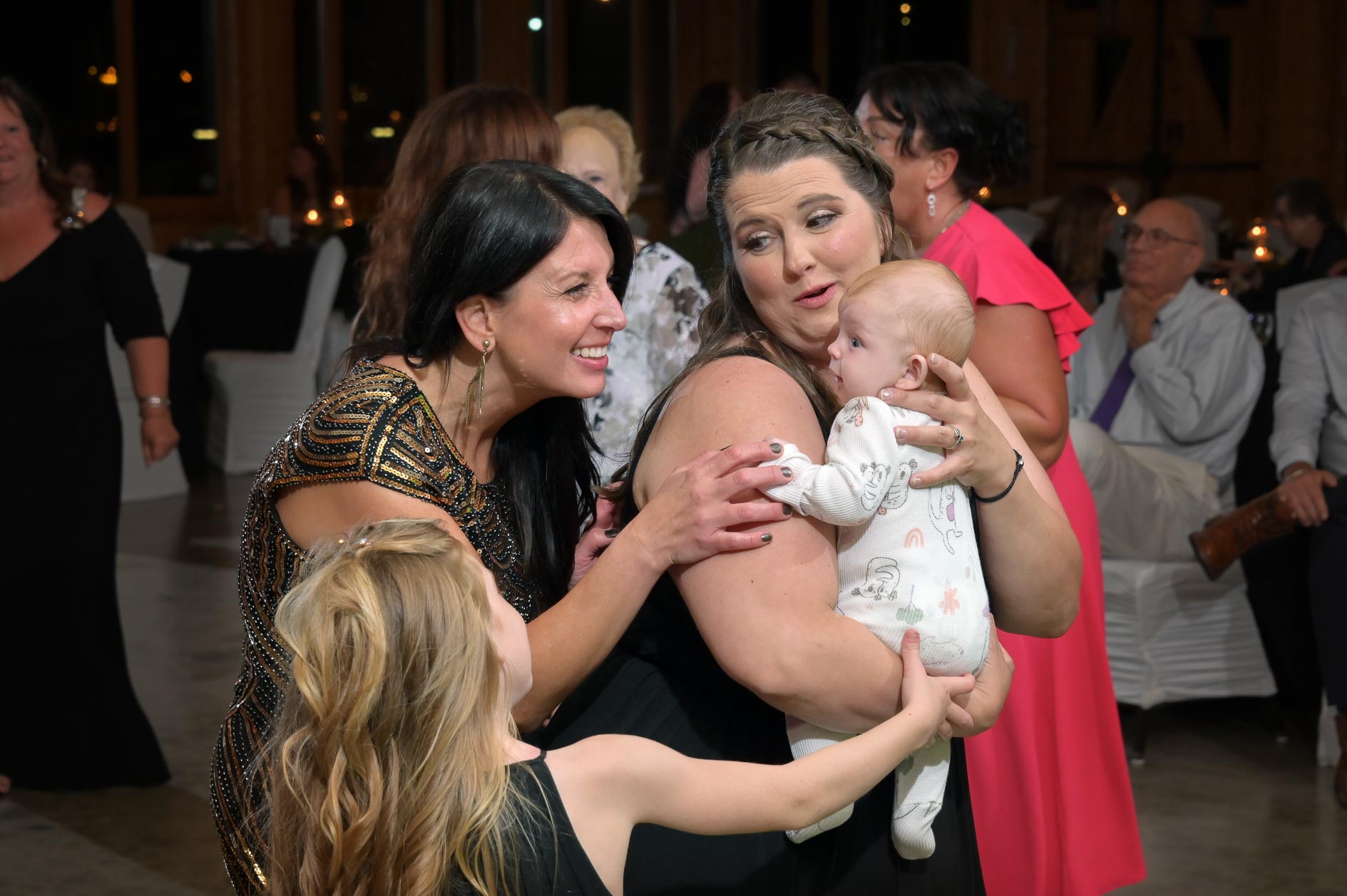 Guests want to play with the baby on the dance floor at Solitude Links Golf Course in Kimball, Michigan.
