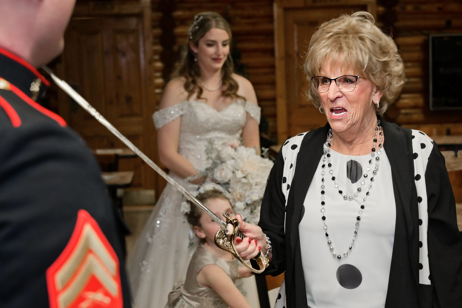 An elderly guest take a Marine's sword and threatens him as sort of a joke at his own wedding in Clarkston, Michigan.