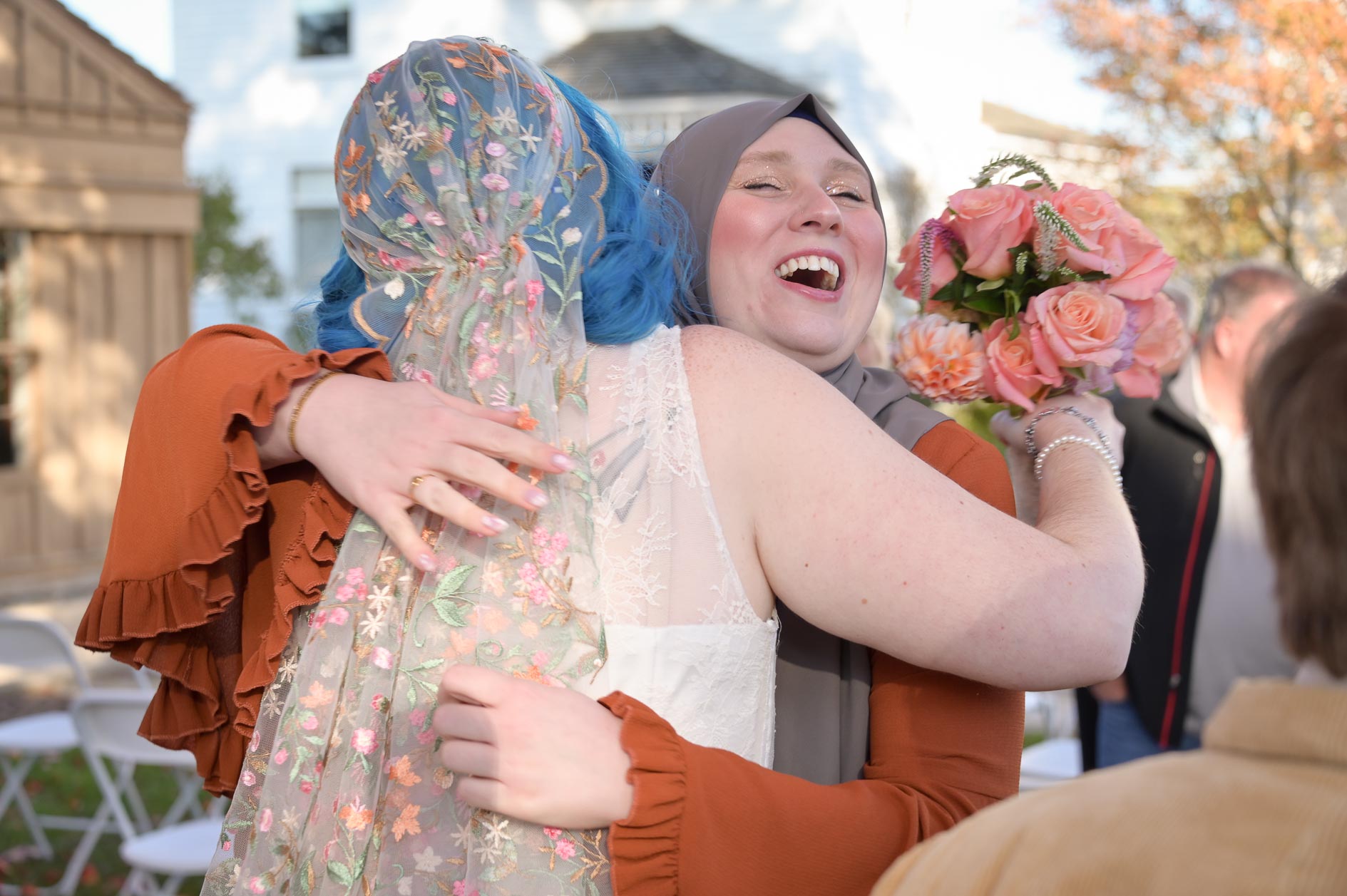 Guest hugging the bride at Troy Historical Society Village in Troy, Michigan.