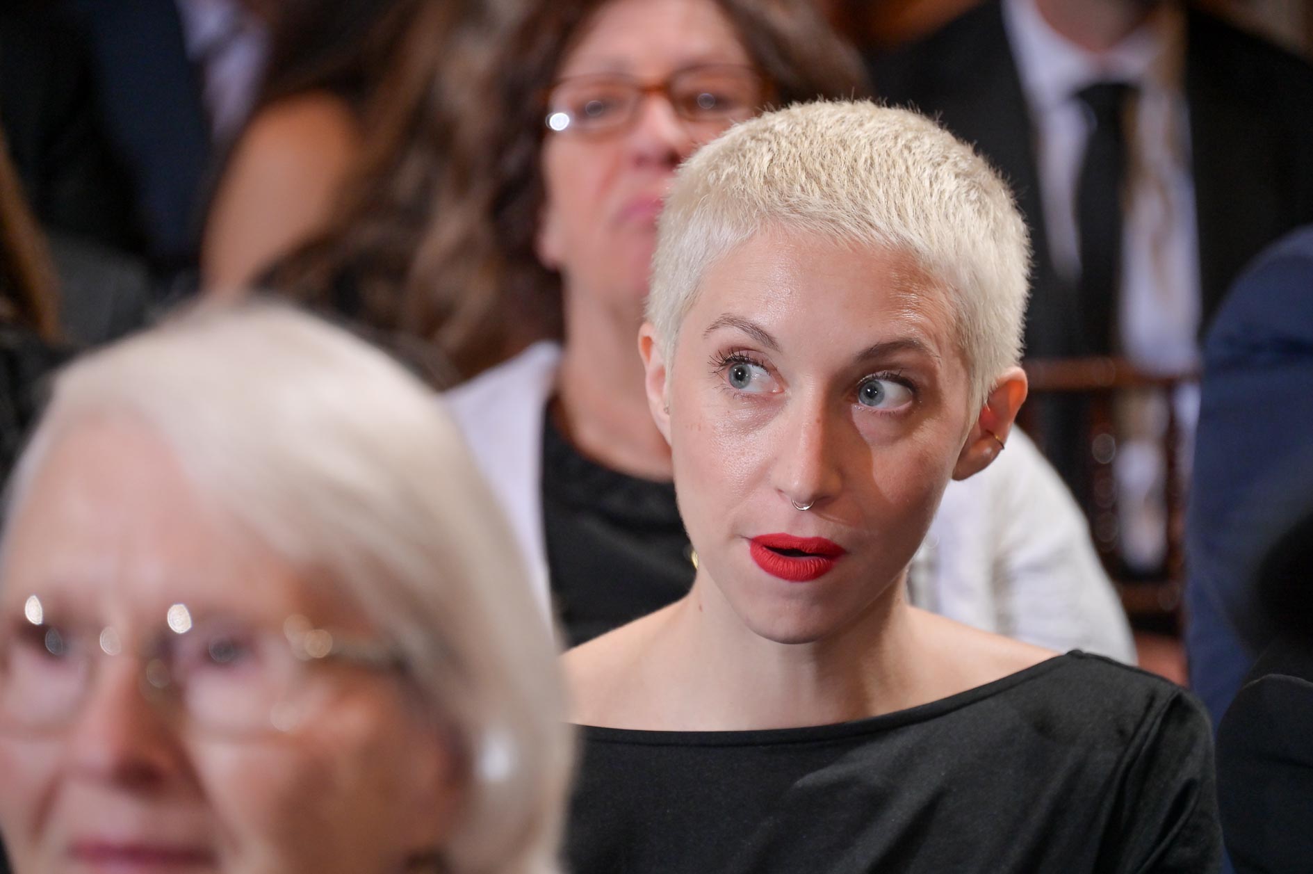 A guest listens to the wedding ceremony attentively at the Gem Theater in Detroit, Michigan.