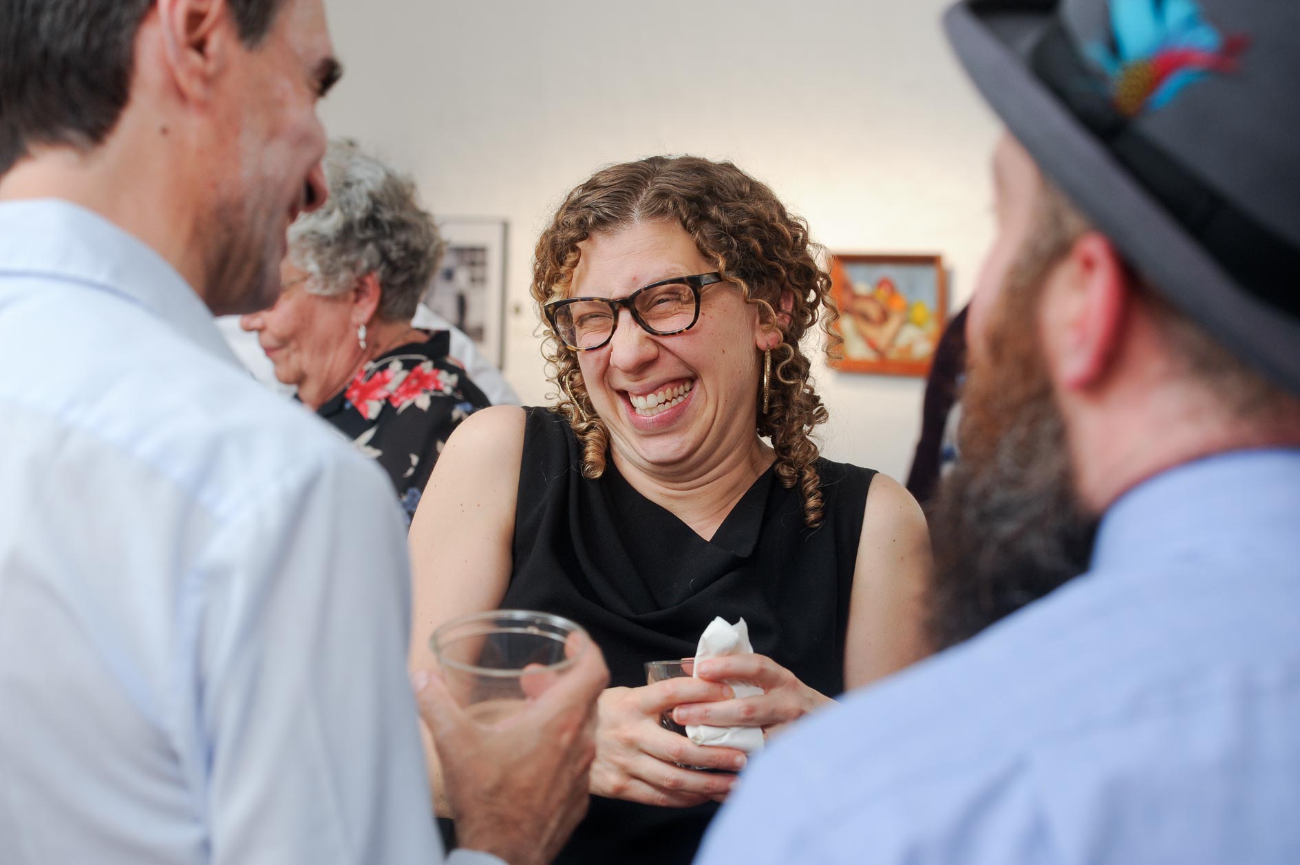 A wedding guest shares a joke with other guest at the Scarab Club Art Gallery to Detroit, Michigan.