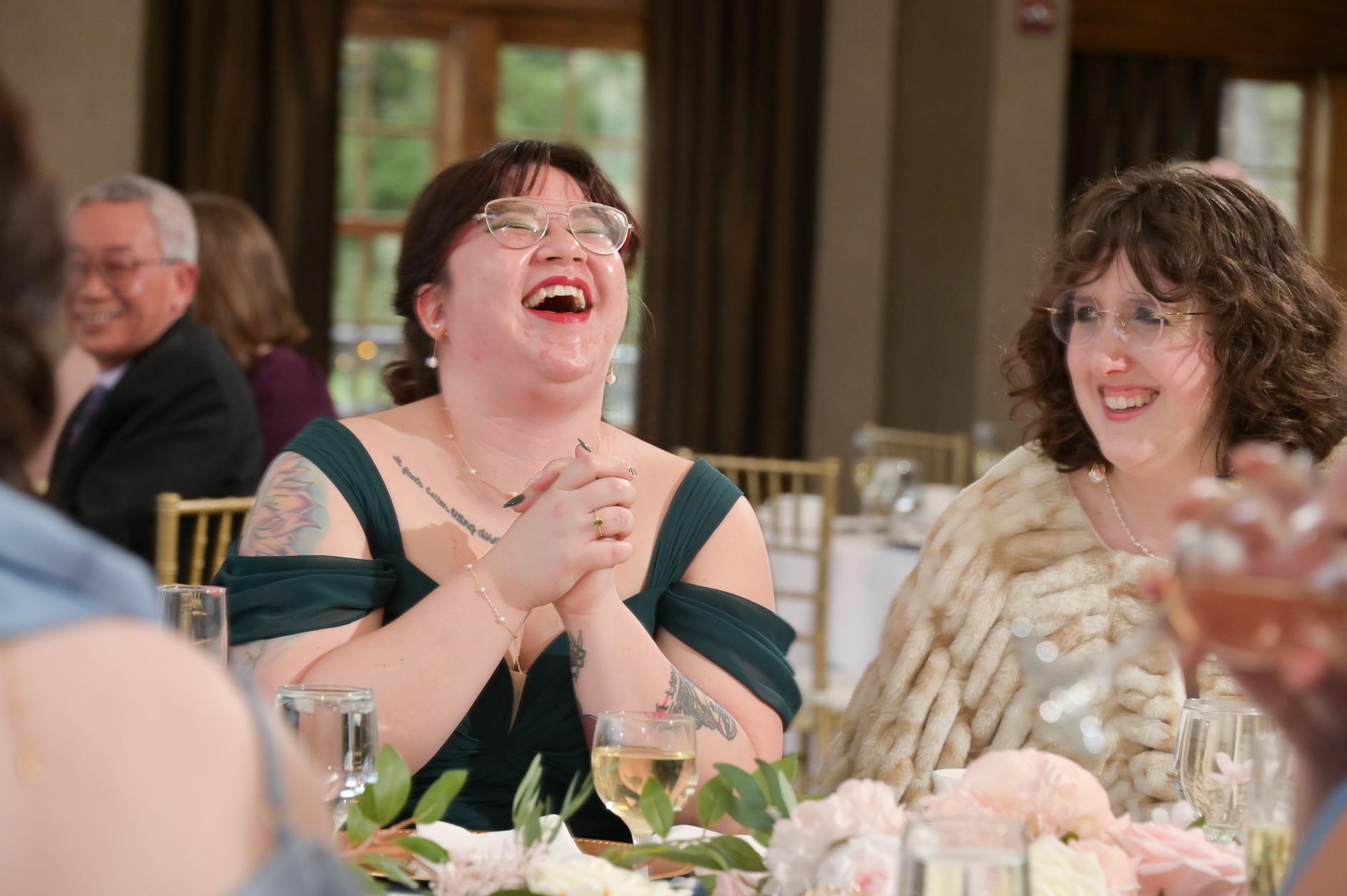 A wedding guest laughs during the speeches at the Buhl Estates at Addison Oaks in Leonard, Michigan.