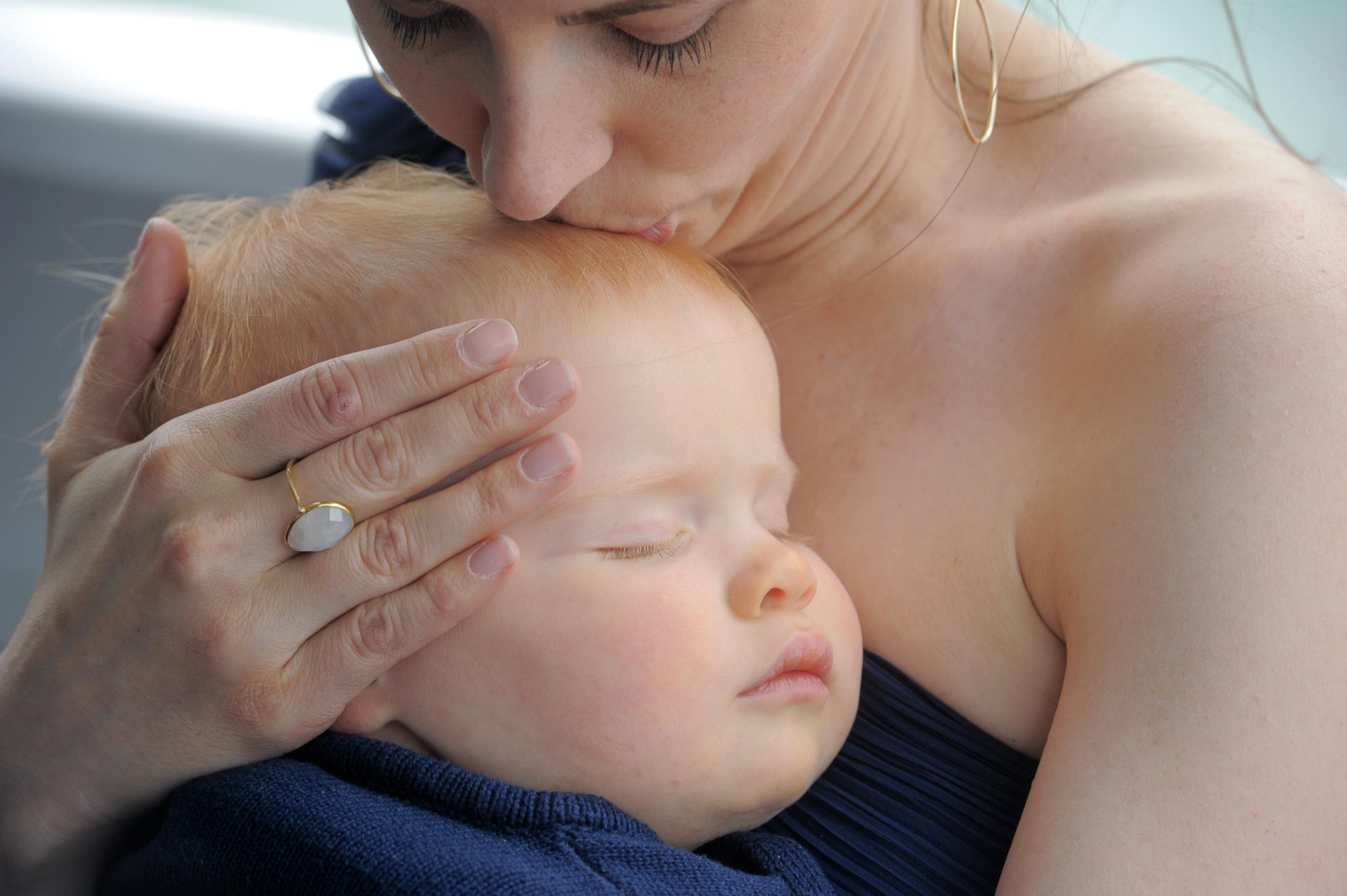 A wedding guest tends to her sleeping baby on an Ovation Cruise along the Detroit River in Michigan.