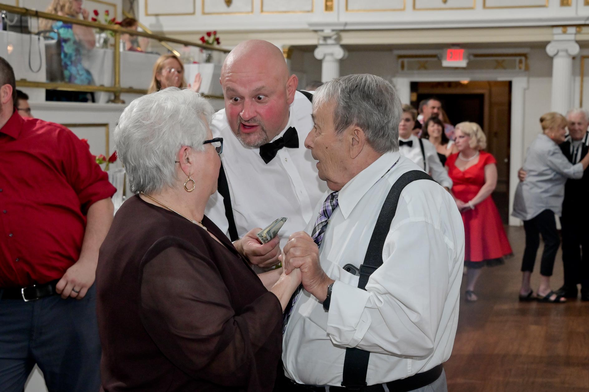 A wedding guest tries to pay a guest for something innocent, I'm sure during a wedding at Lafayette Grand in Pontiac, Michigan.