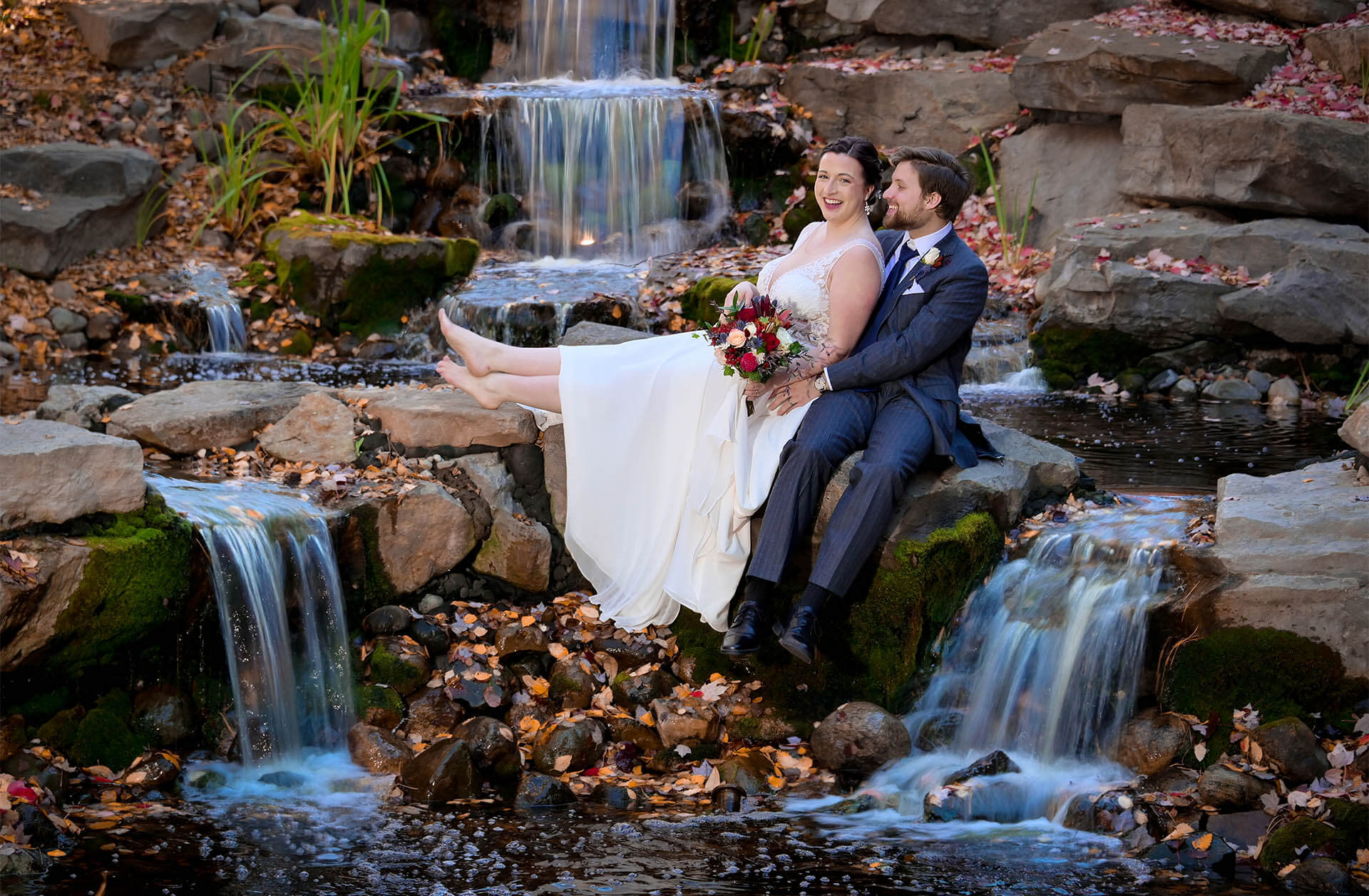 A Slightly older couple lounge in amongst the waterfalls at the Resort at St. Johns in Plymouth, Michigan.