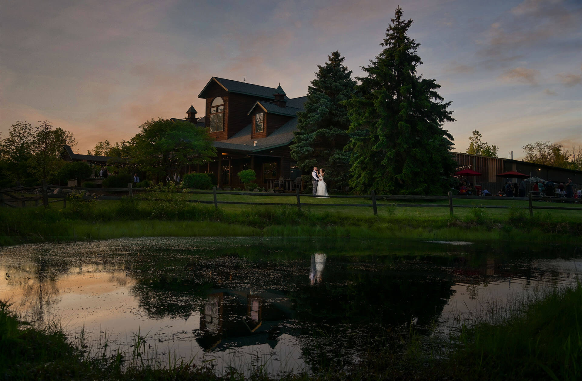 A couple snuggle at sunset at the Fenton Brewery in Fenton, Michigan for a dramatic, epic portrait.