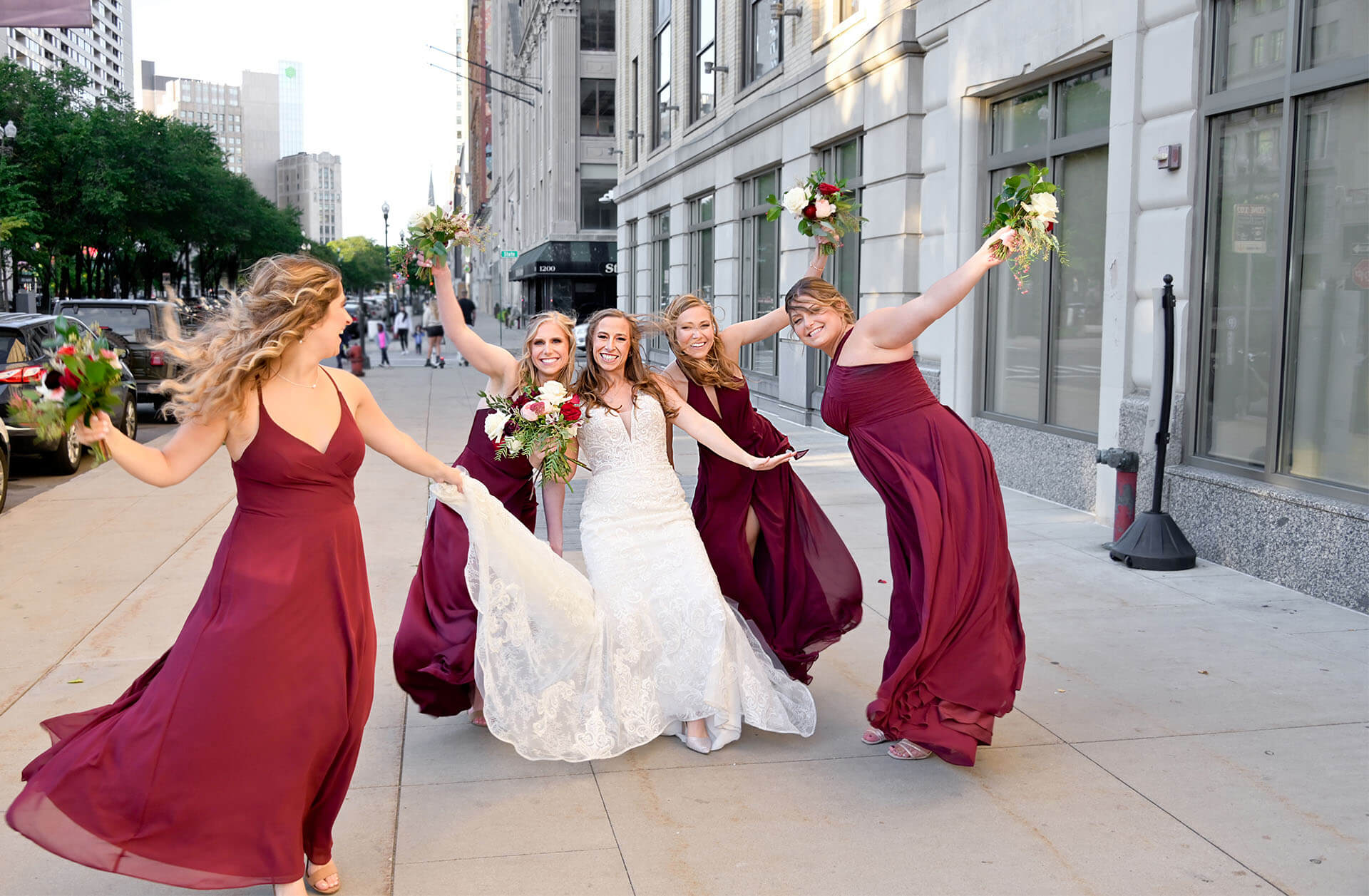 A wind storm doesn’t deter the bride and her bridesmaids from stepping out at the Westin Book Cadillac Hotel in Detroit, Michigan..