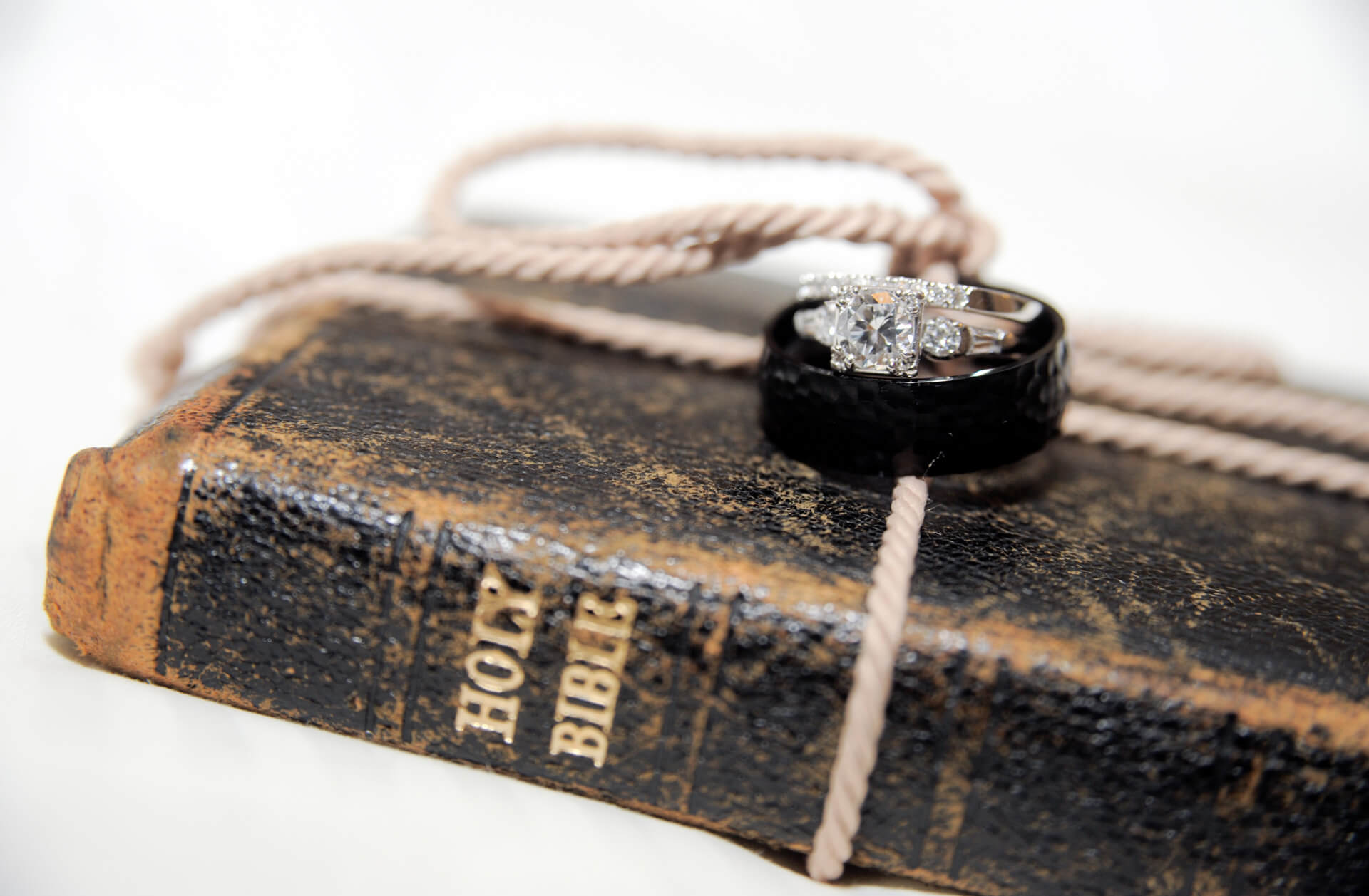 Epic Wedding portrait showing of the couple's family bible with their wedding rings at the Royal Park Hotel in Rochester, Michigan.