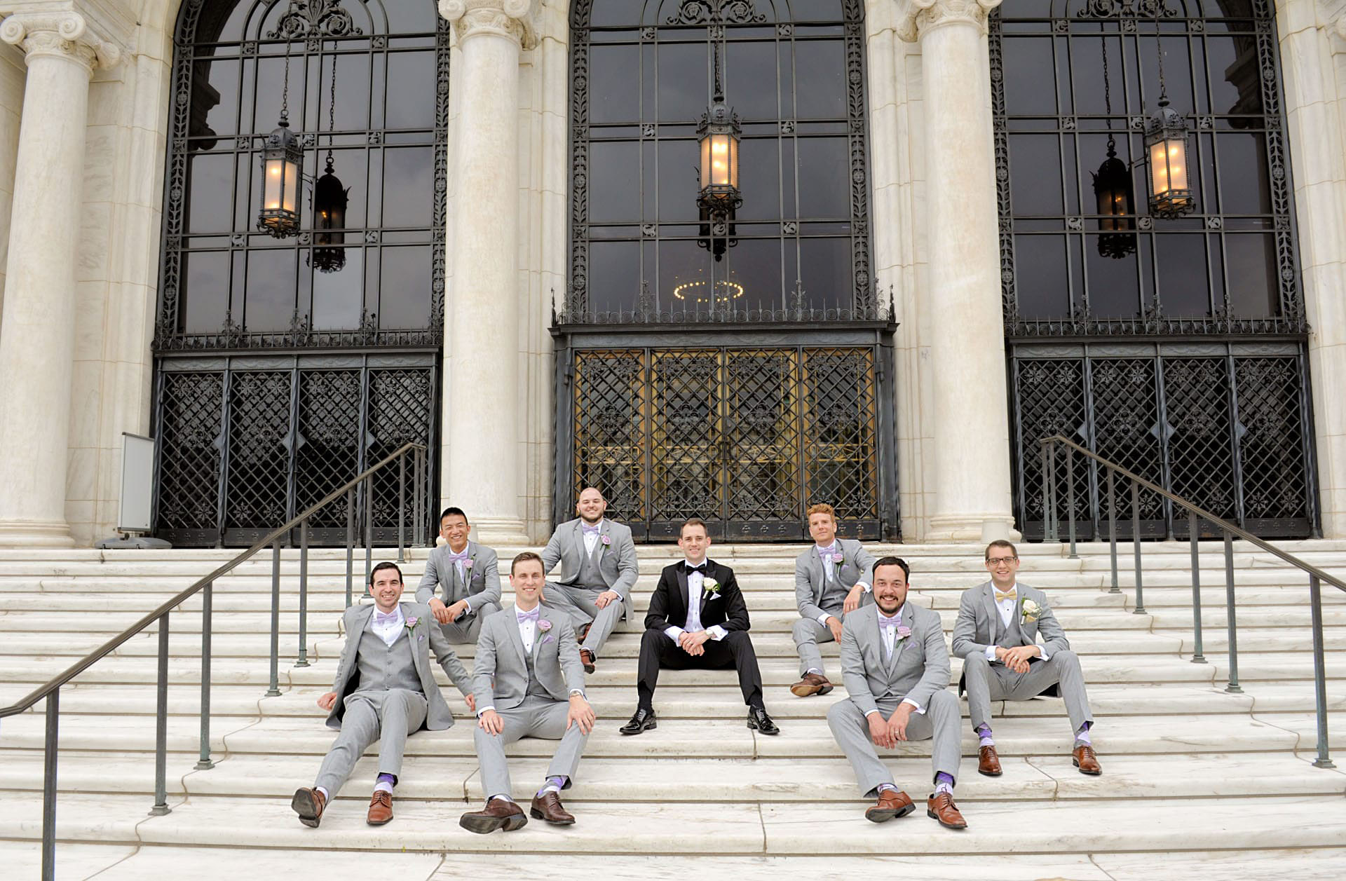 Epic Wedding portrait showing the groomsmen sitting in front of the DIA in Detroit, Michigan.