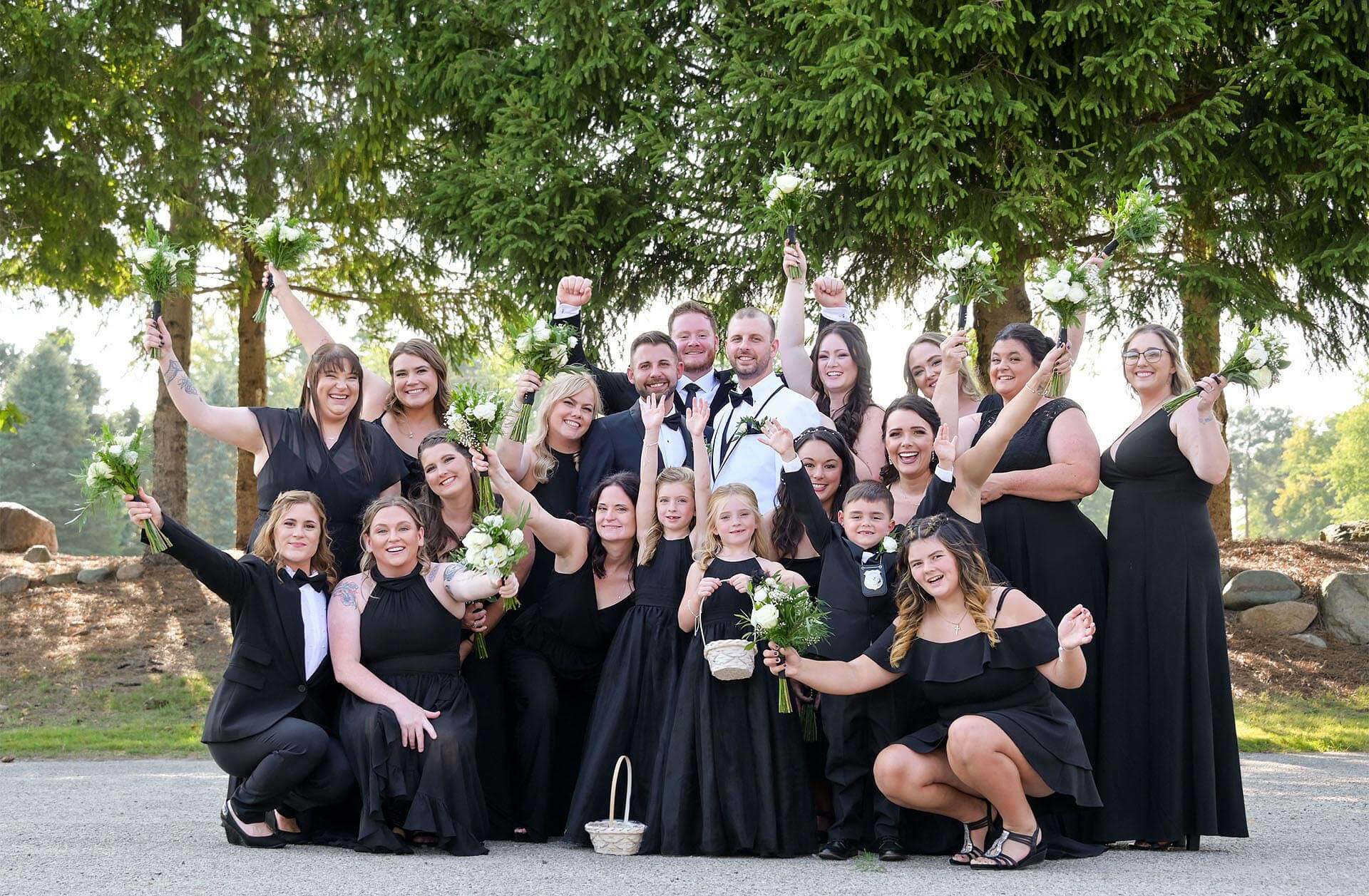 A gay, same sex couple celebrate their wedding at Solitude Links in Kimball, Michigan surrounded by their loving and enthusiastic wedding party.