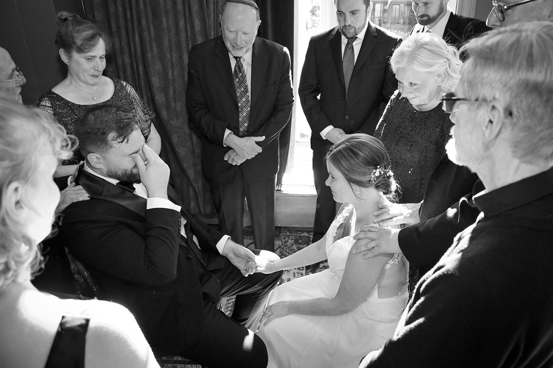 The couple surrounded by family during the Ketuba signing ceremony at the Gem Theatre in Detroit, Michigan.