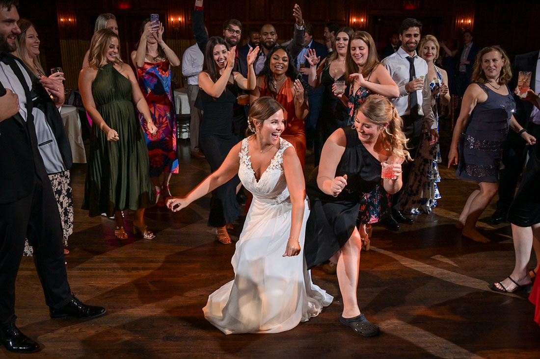 The bride giving it her all on the dance floor with a guest after her wedding at the Gem Theatre in Detroit, Michigan