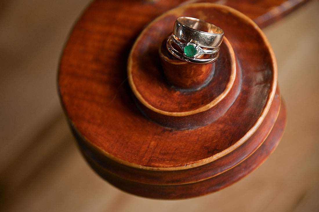 The couples' rings on the end of a cello, a nod to one of the couple's love of music before their wedding at their AirBnb in Grass Lake, Michigan.
