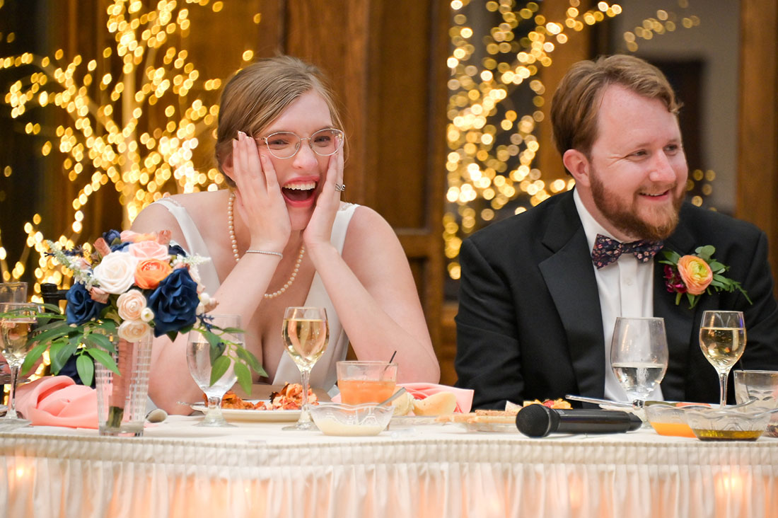 The couple react to a hilarious speech from the bride's brother after their wedding at the Lakeview Banquet and Event Center in Laingsburg, Michigan.