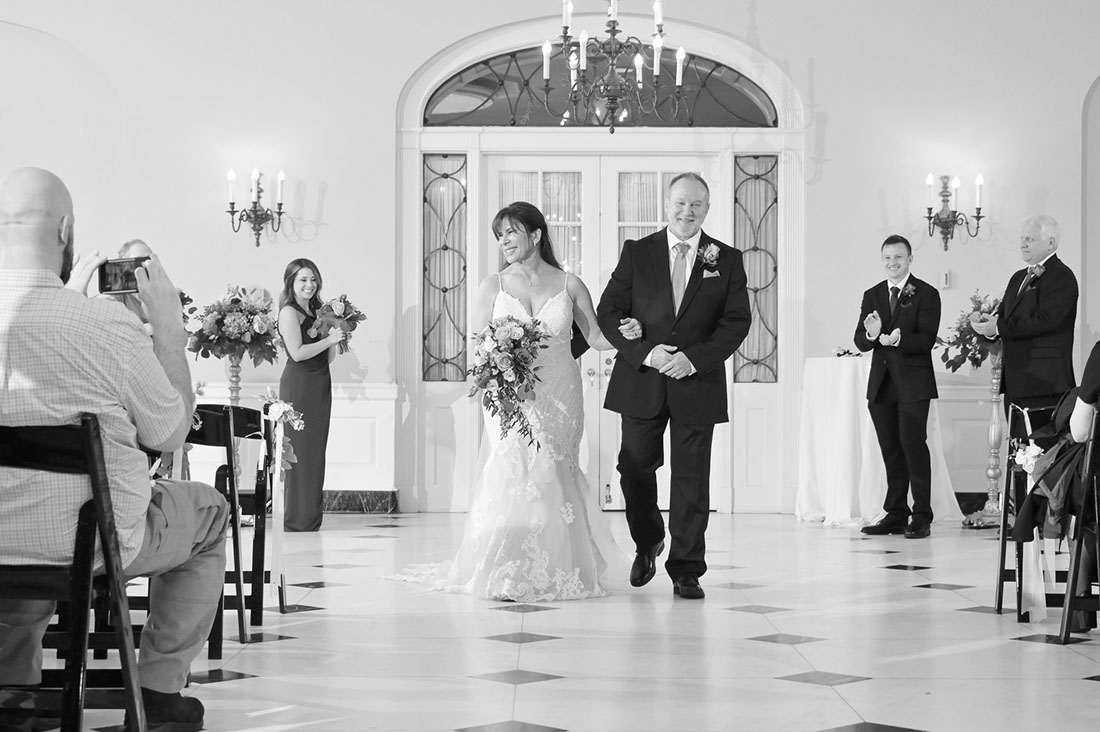 The bride and groom exiting their wedding ceremony at Lovett Hall at the Henry Ford Museum in Dearborn, Michigan.